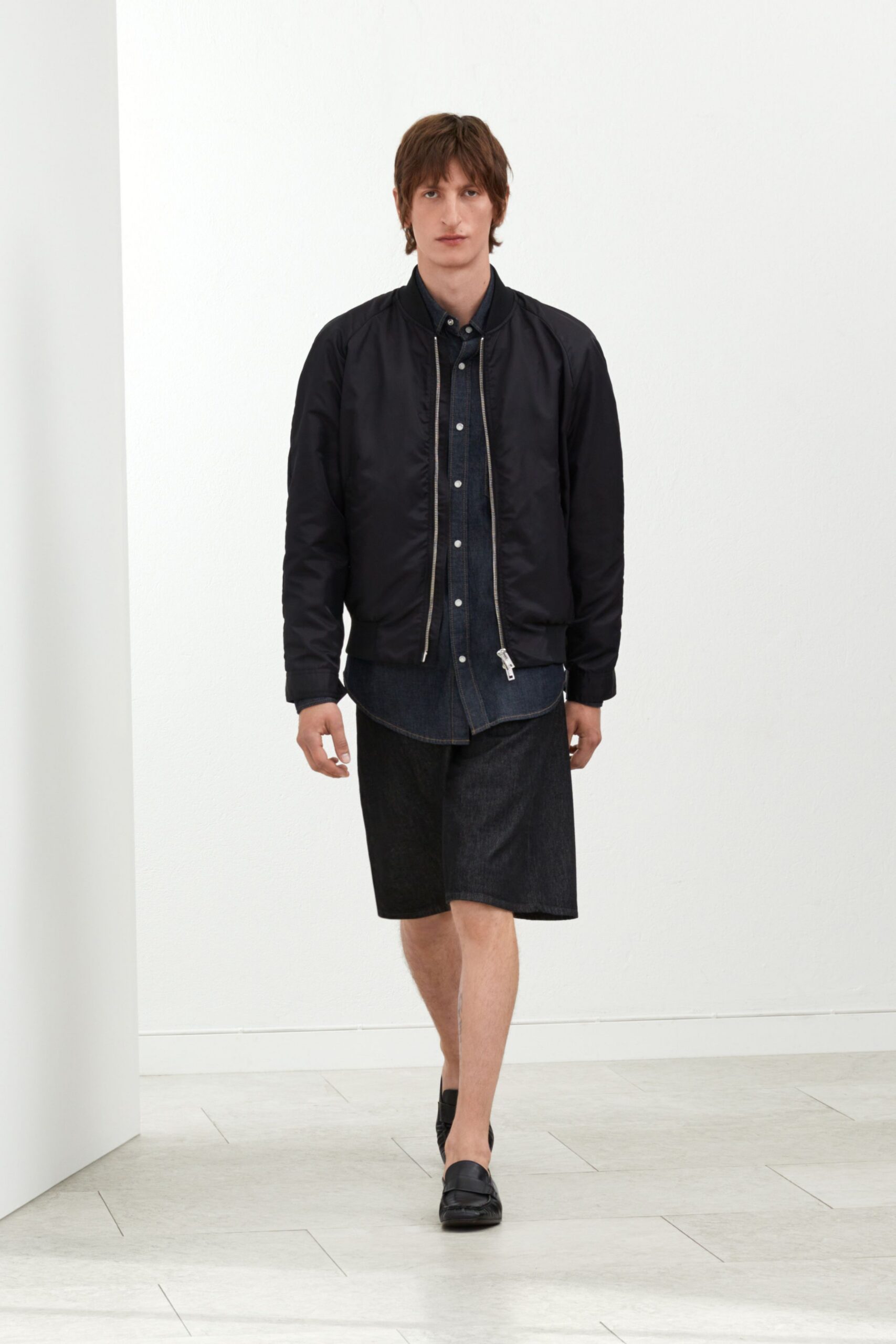black jacket blue shirt denim shorts