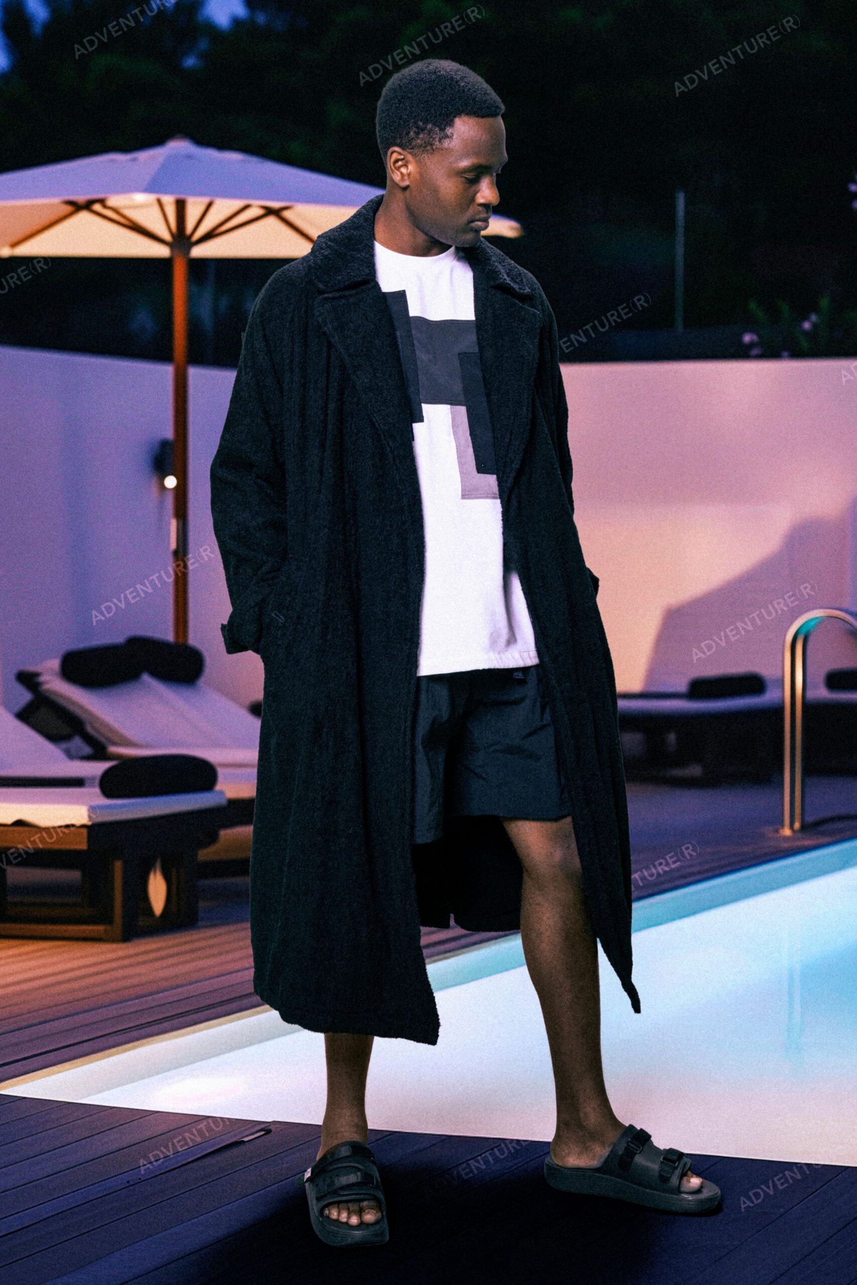 black faux-fur coat with t-shirt and shorts