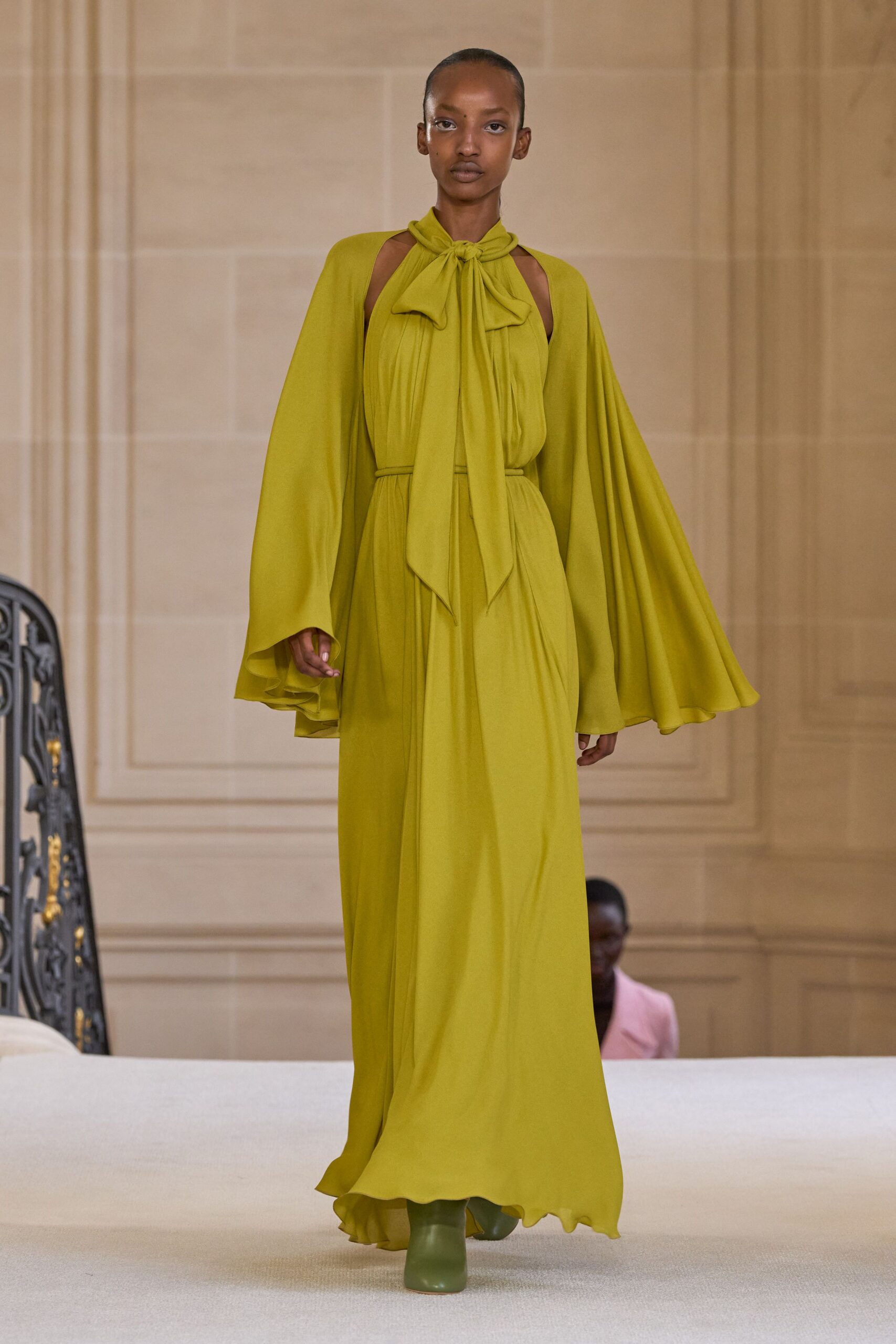 green silk long-sleeve high-neck fitted draped flowing gown