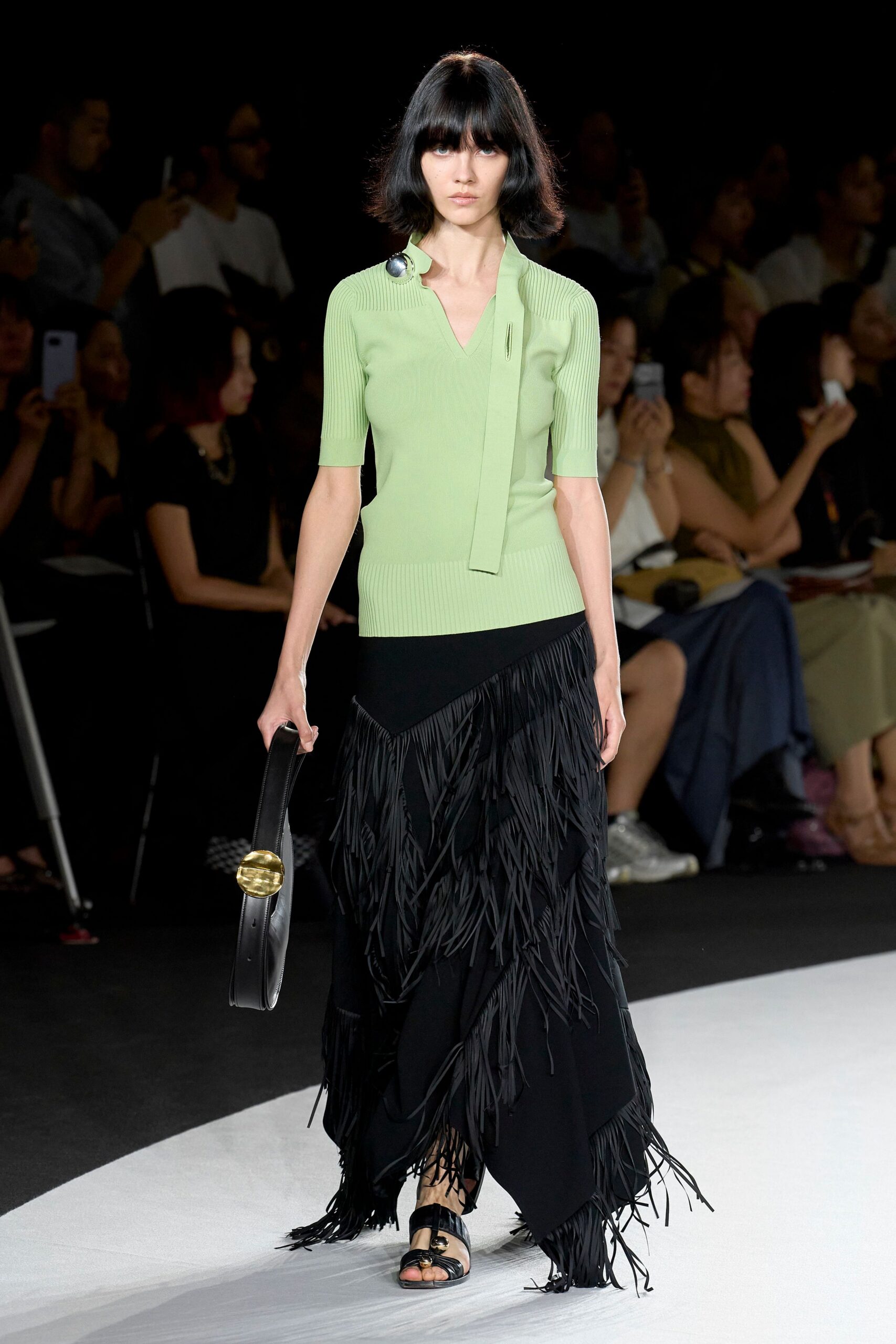 green fitted top black fringed skirt
