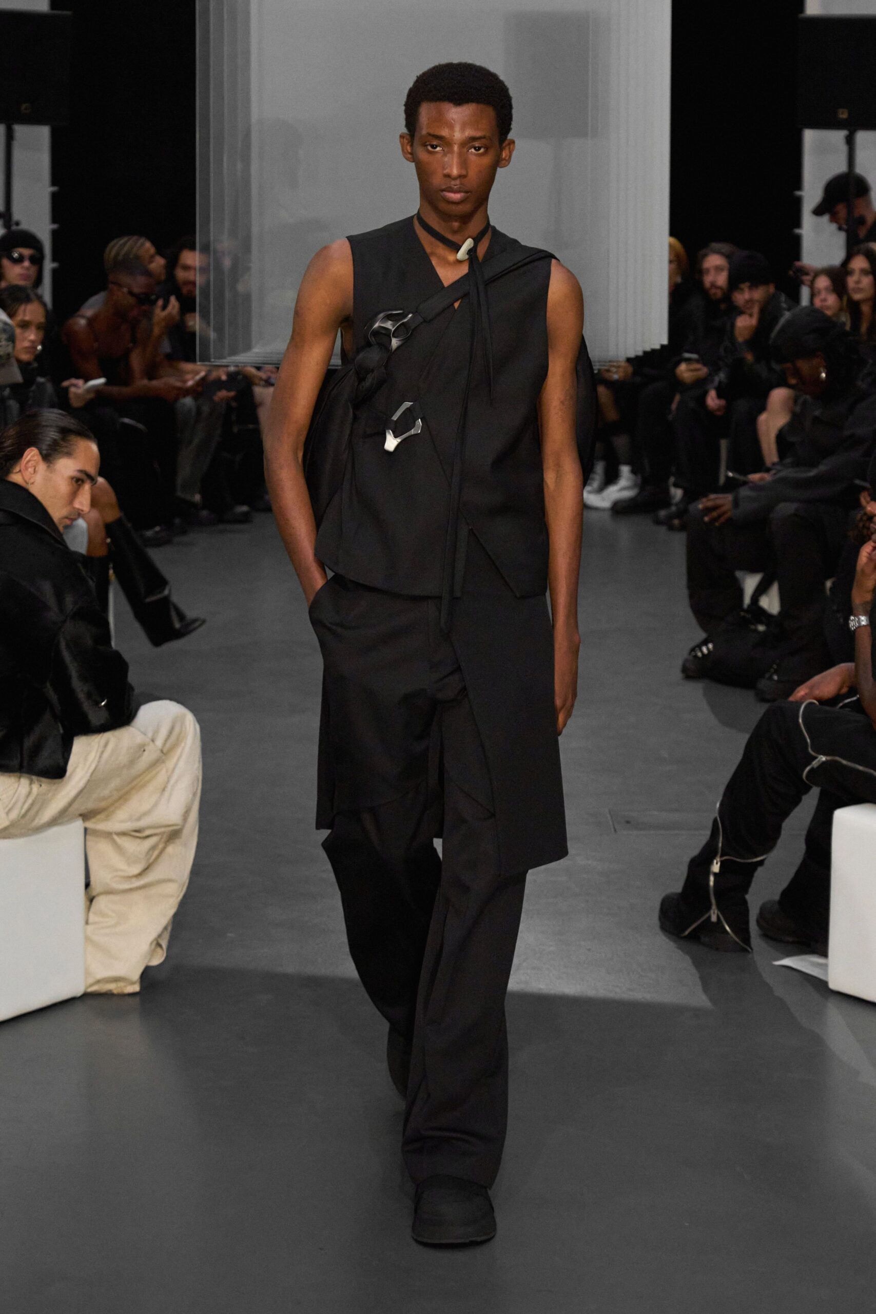 black fitted vest and relaxed pants