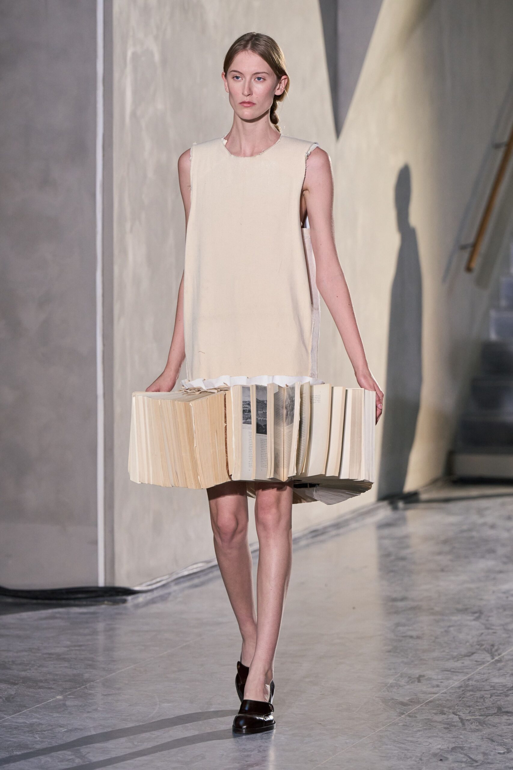 beige sleeveless mini dress with black shoes