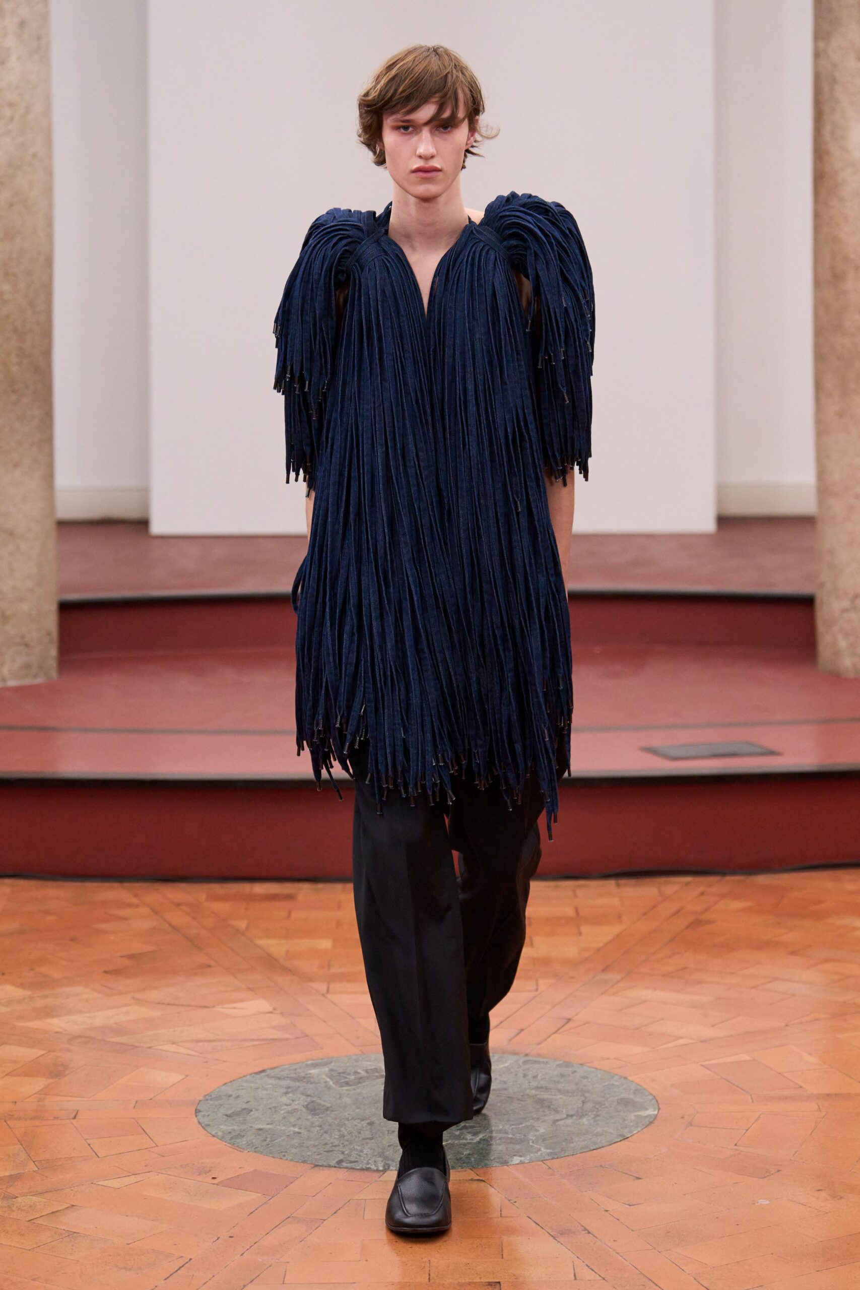 blue fringed top with black pants