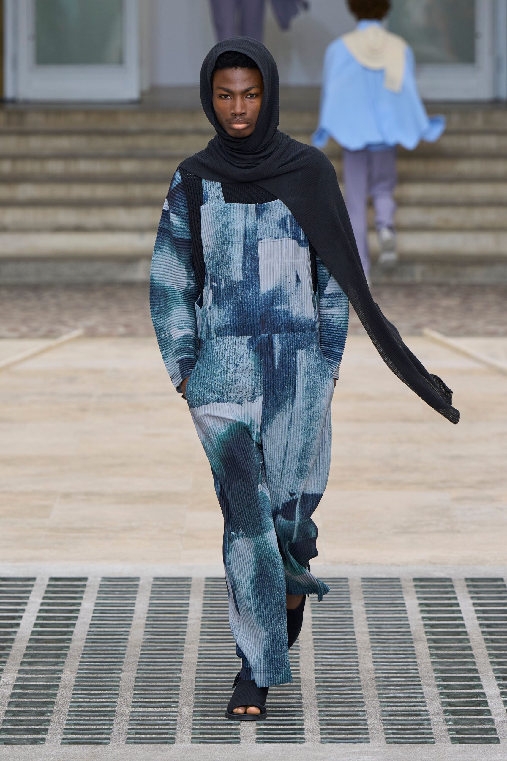blue green printed jumpsuit with black scarf