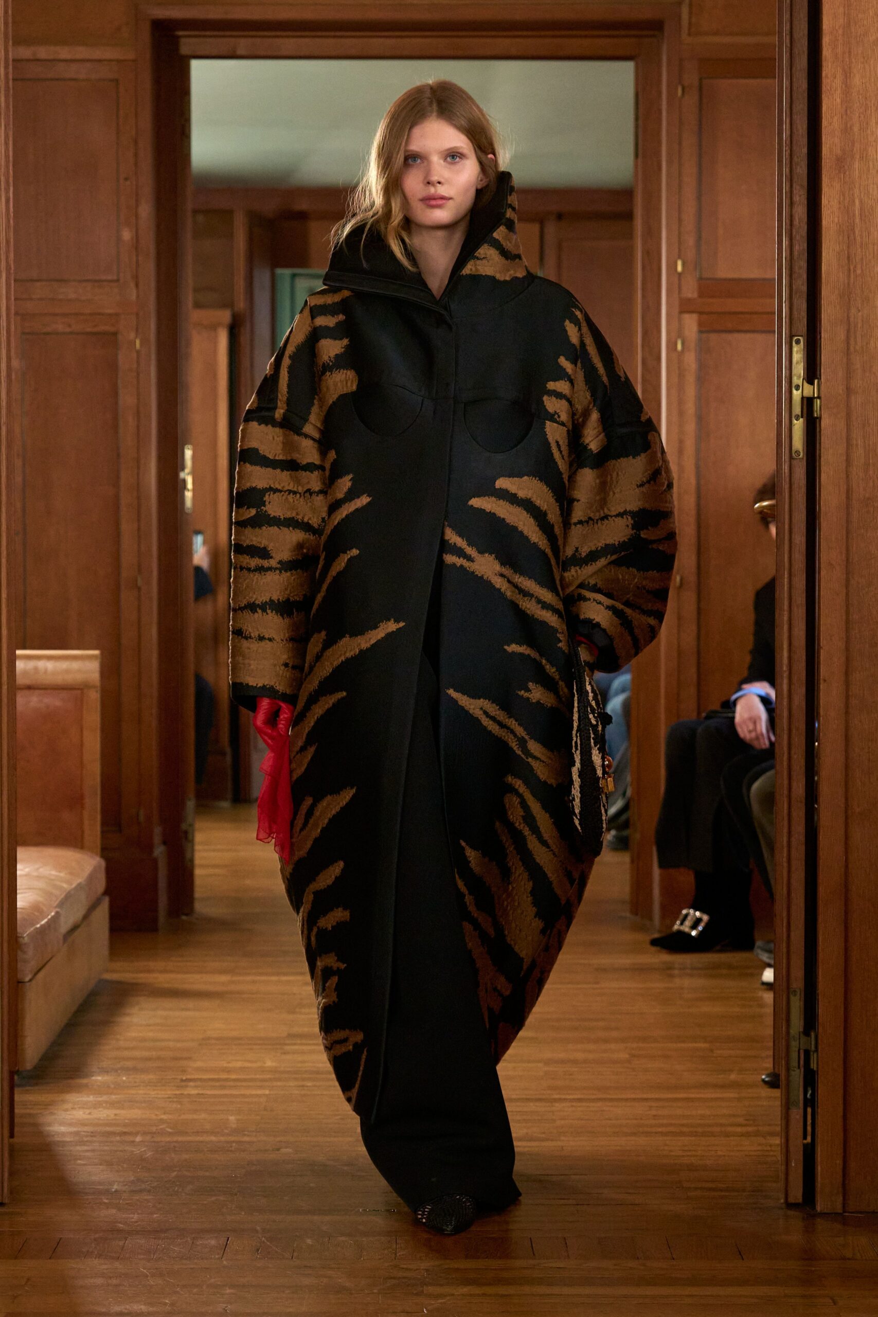 oversized animal-print coat with red gloves