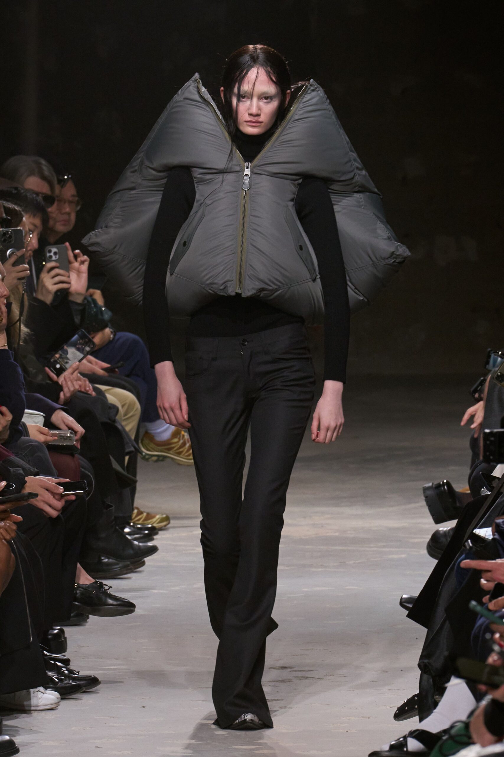 gray padded jacket with black pants