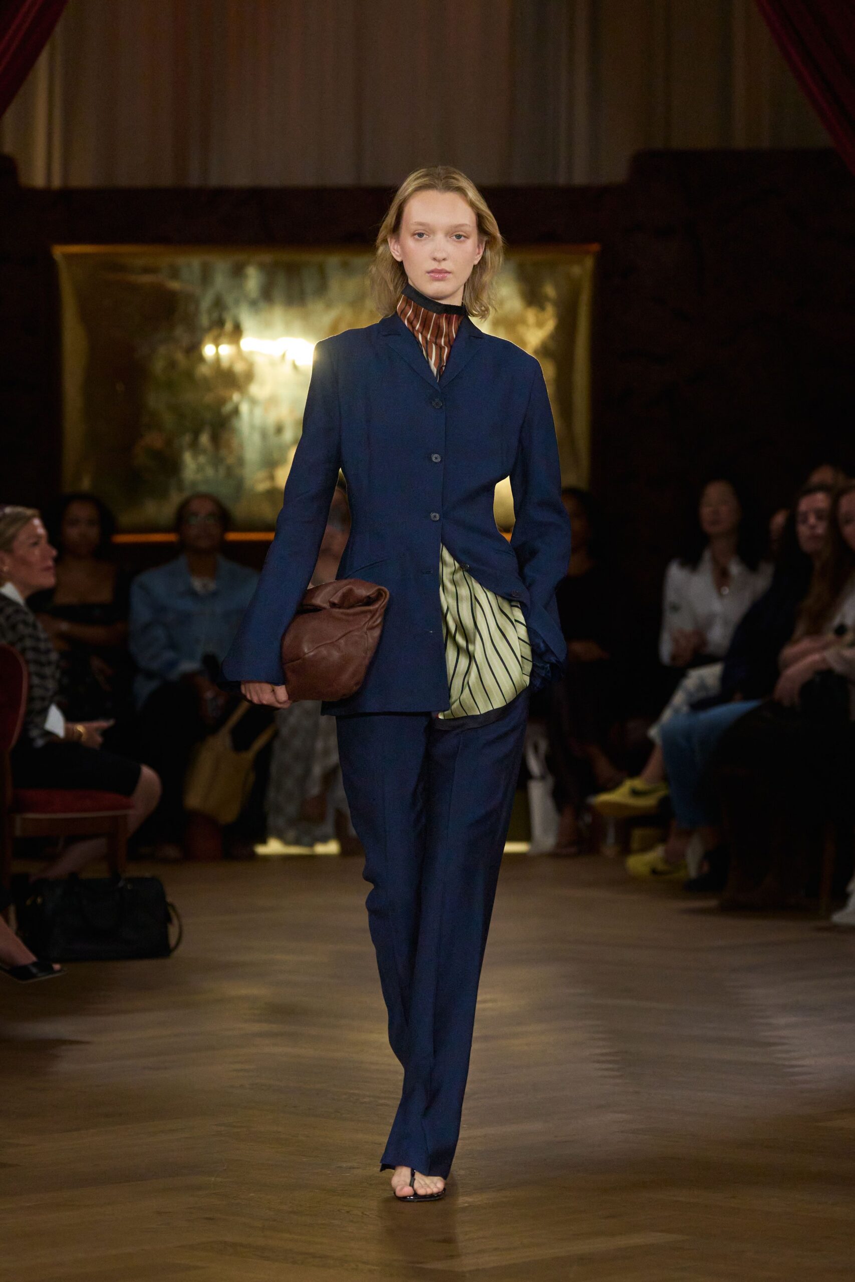 blue tailored suit with brown bag