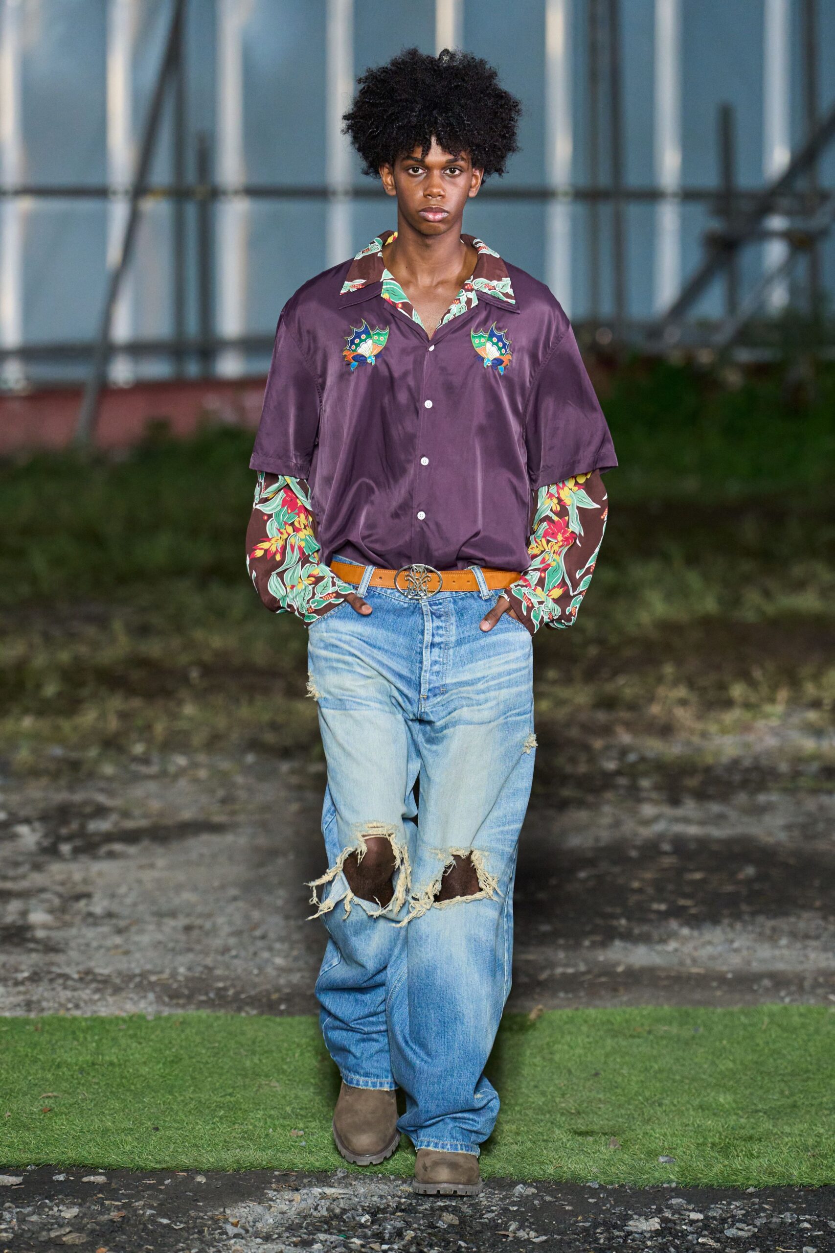 purple embroidered shirt with distressed jeans