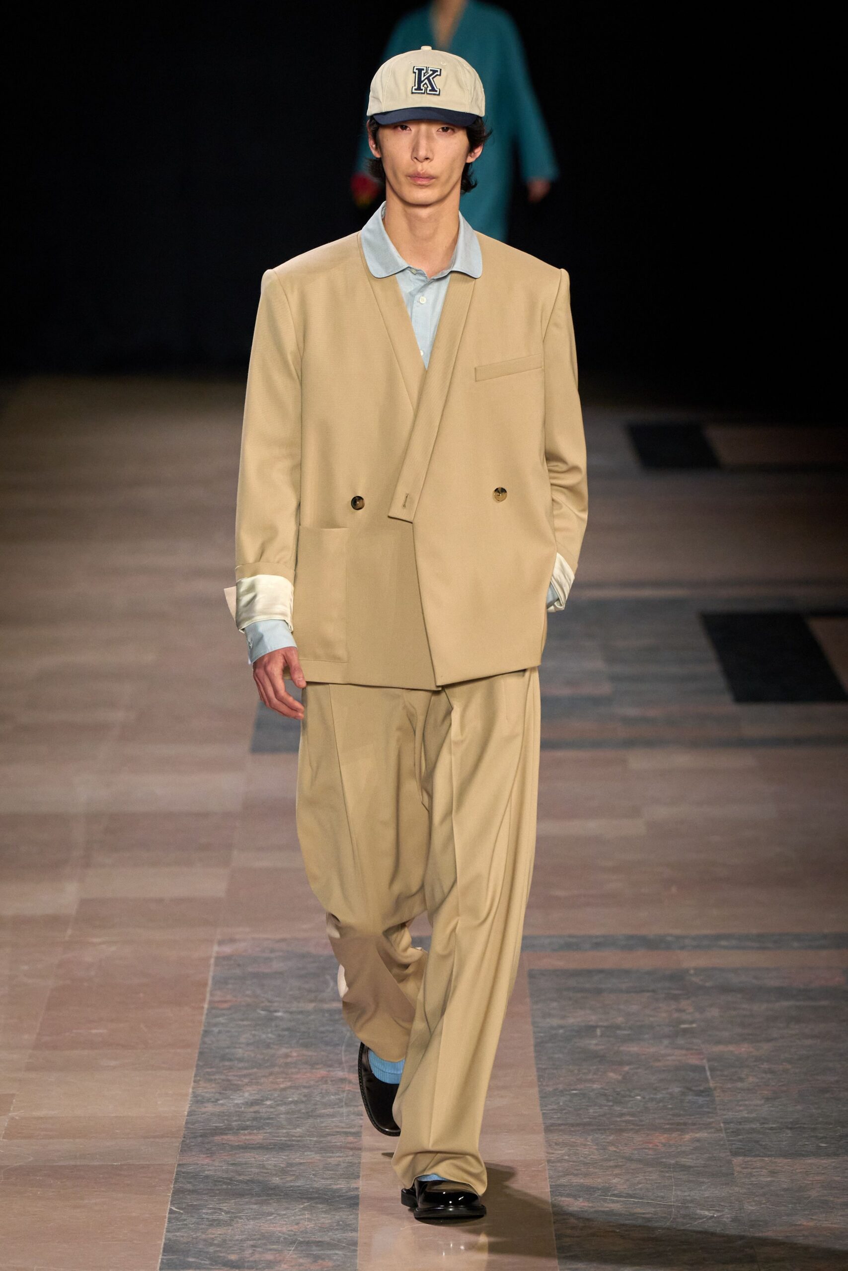 beige tailored suit with blue shirt