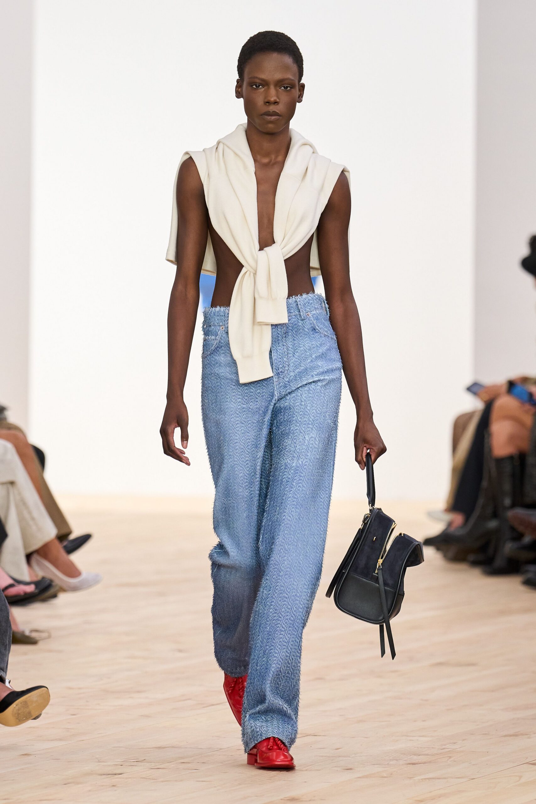 white draped top with blue pants