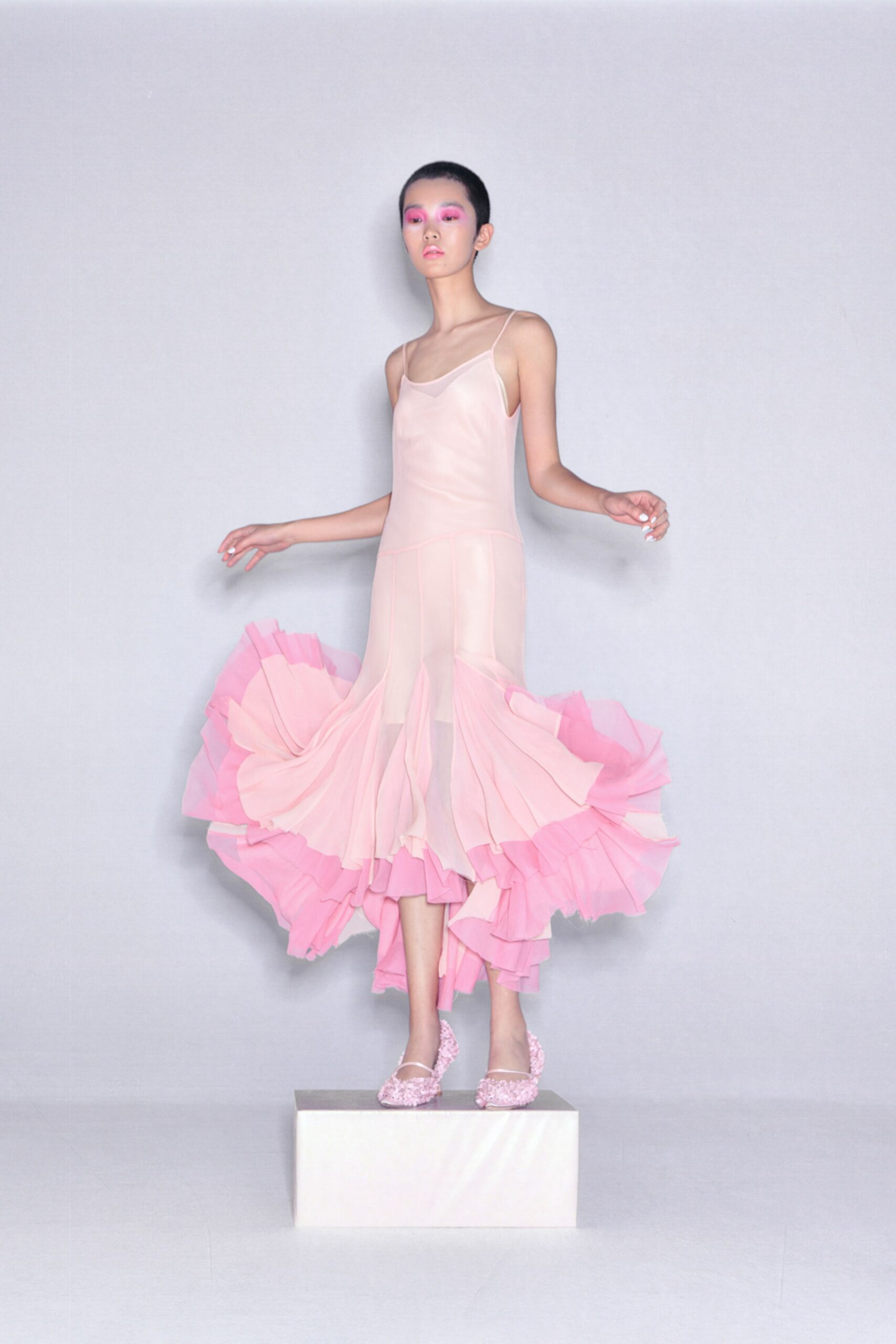 pink pleated midi dress with embellished shoes