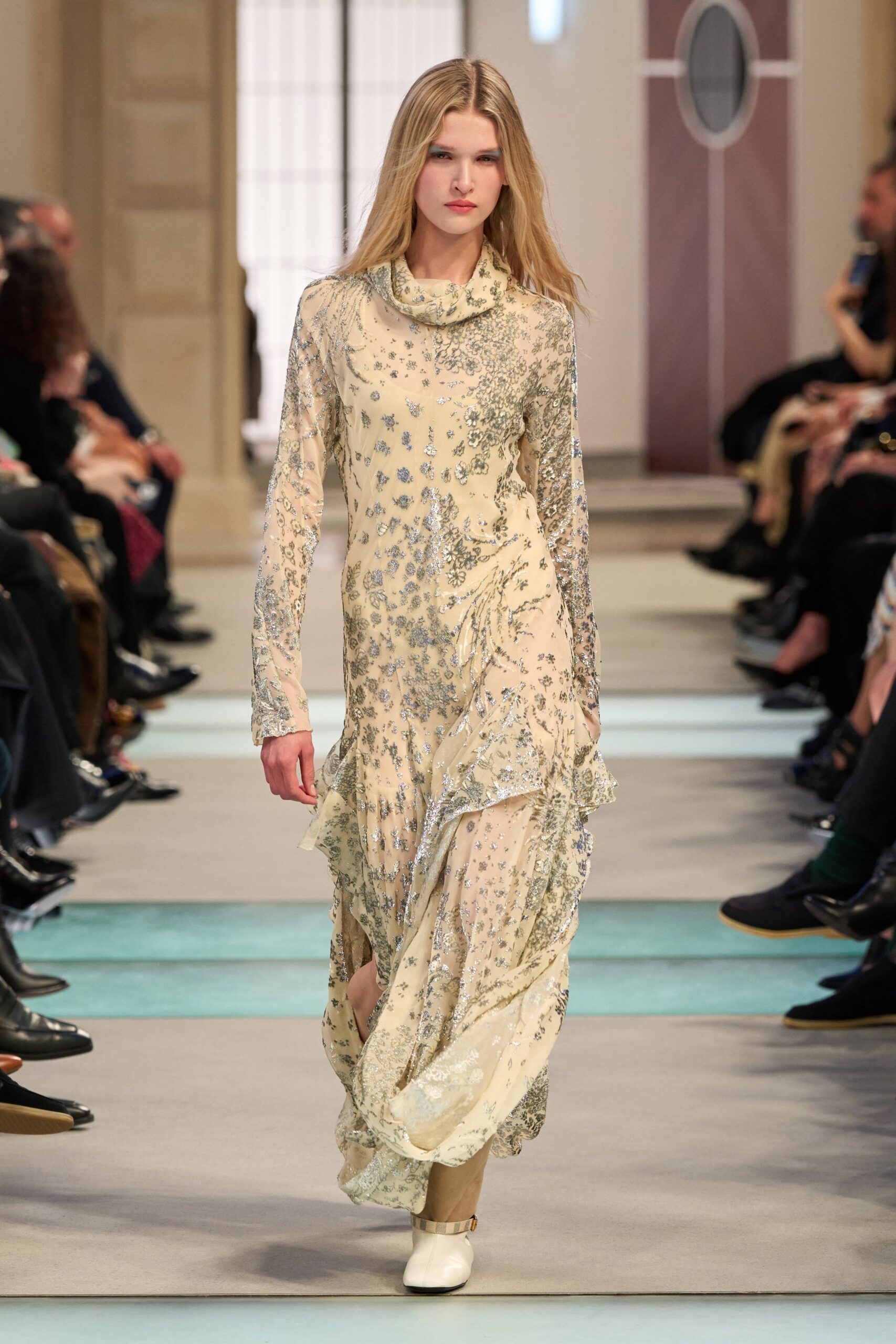 beige embroidered maxi gown with white shoes