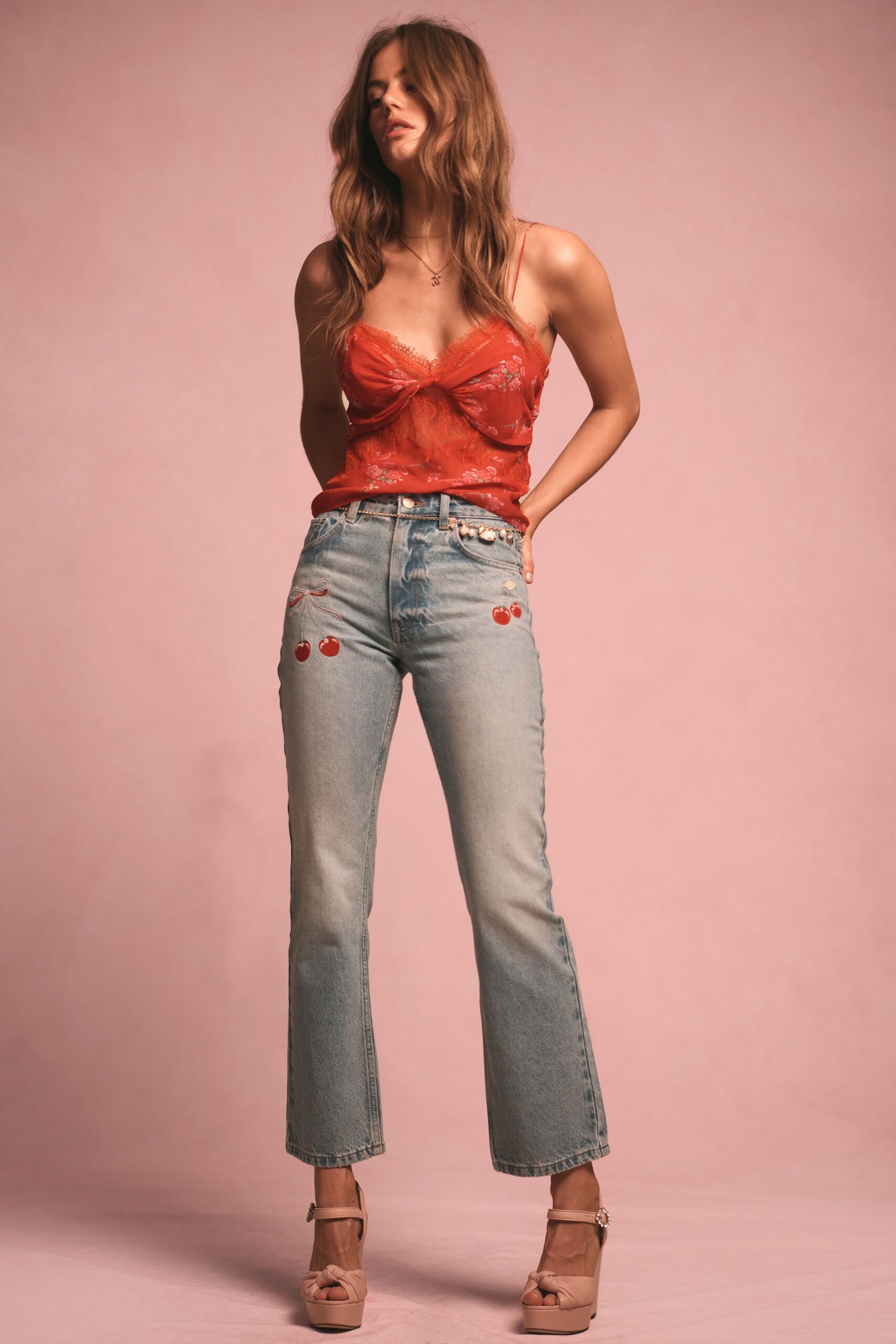 red silk fitted top with flared jeans