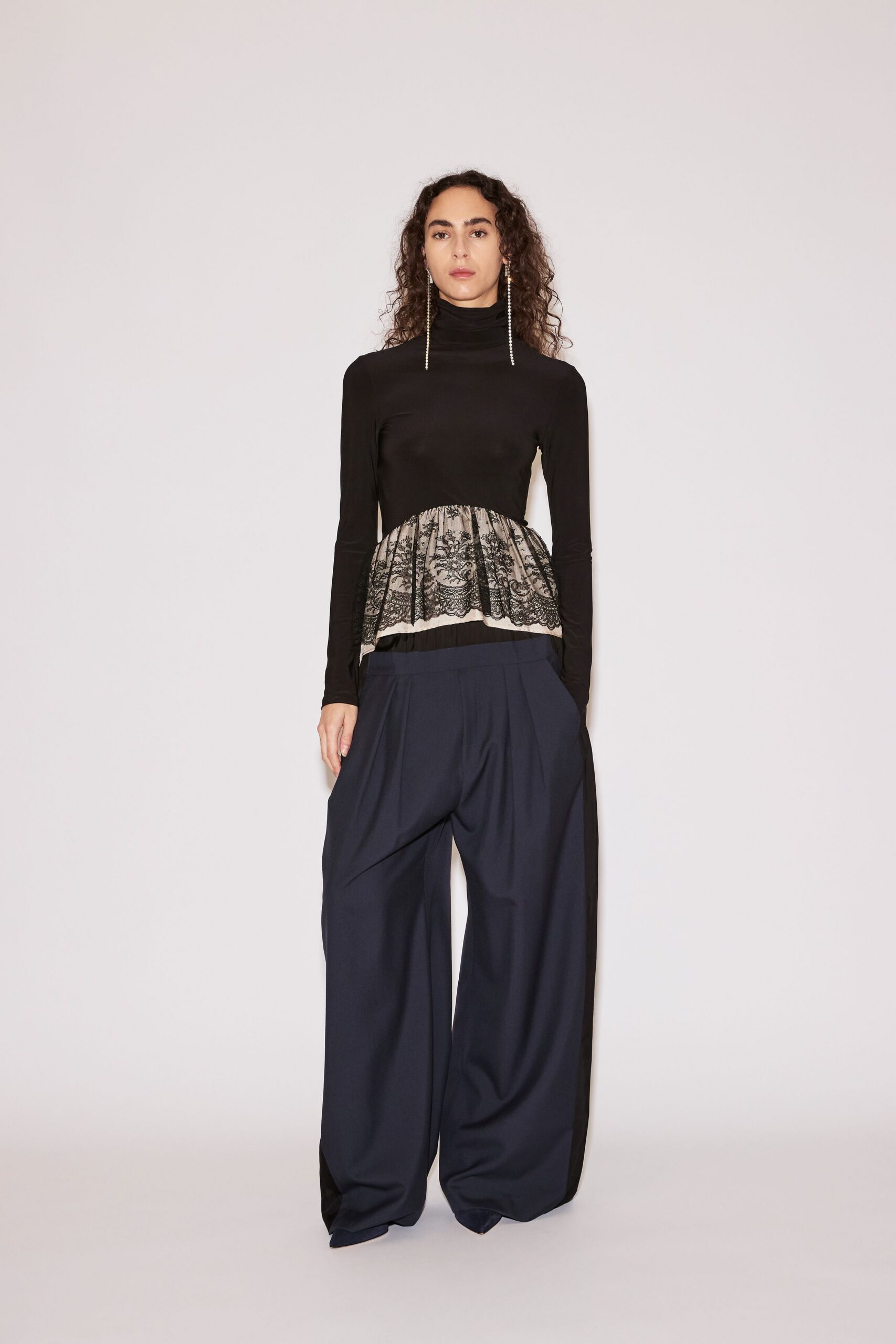 black fitted top and blue wide-leg pants