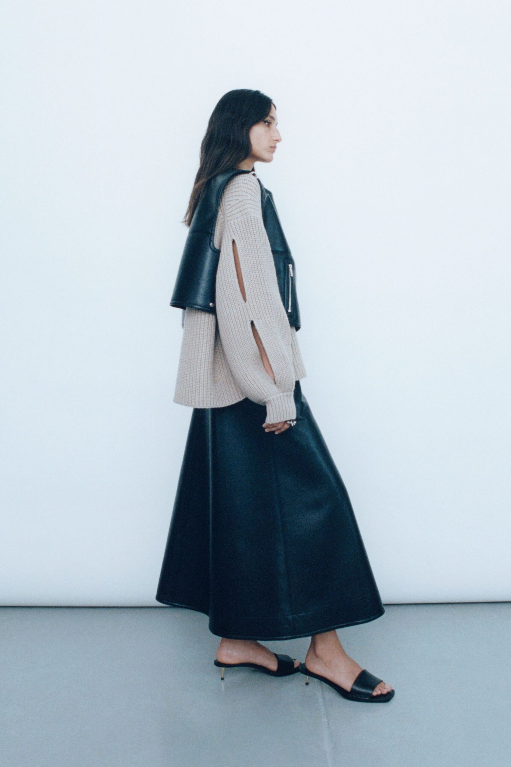 beige relaxed top black leather skirt