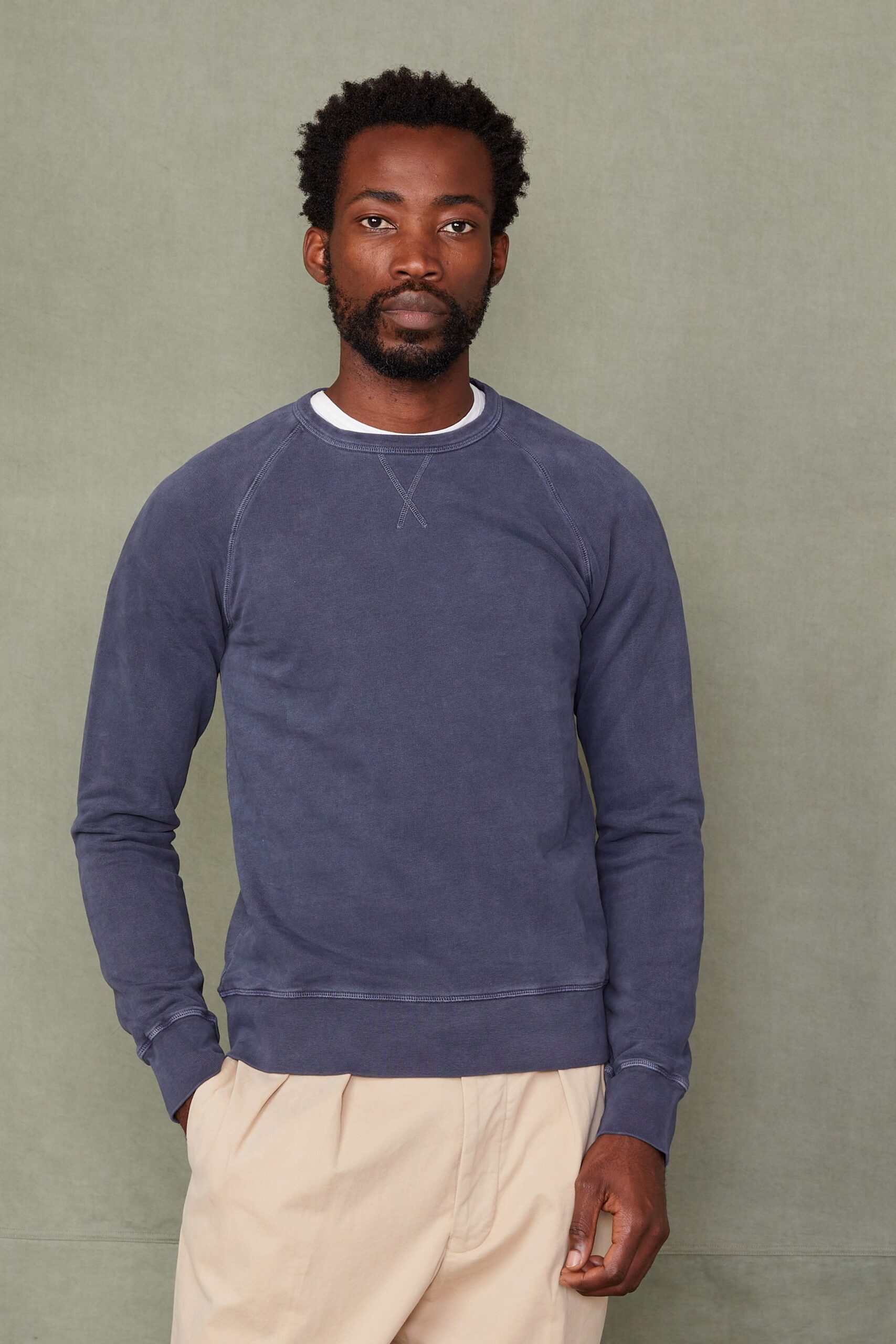 blue relaxed sweater with beige pants