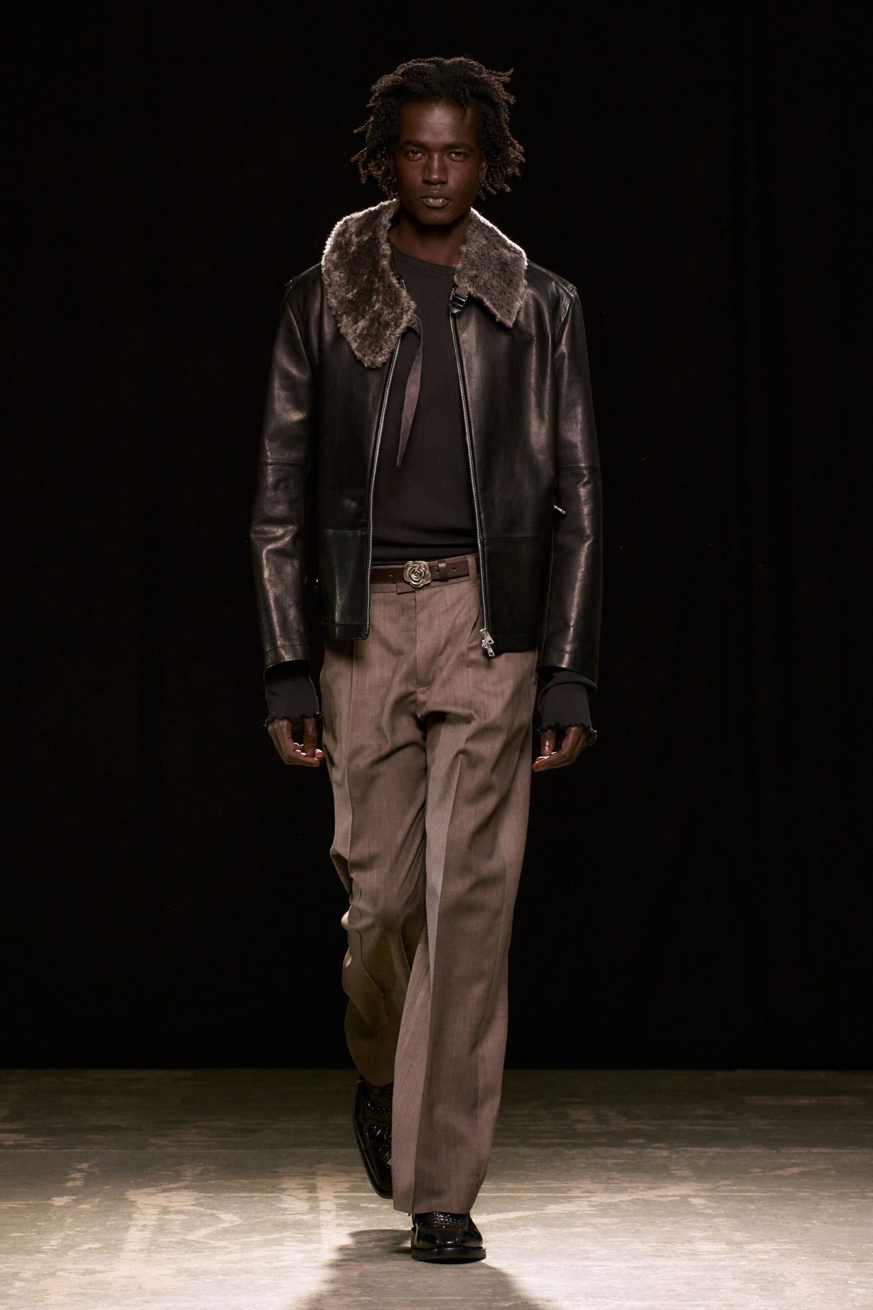 black leather jacket with gray pants