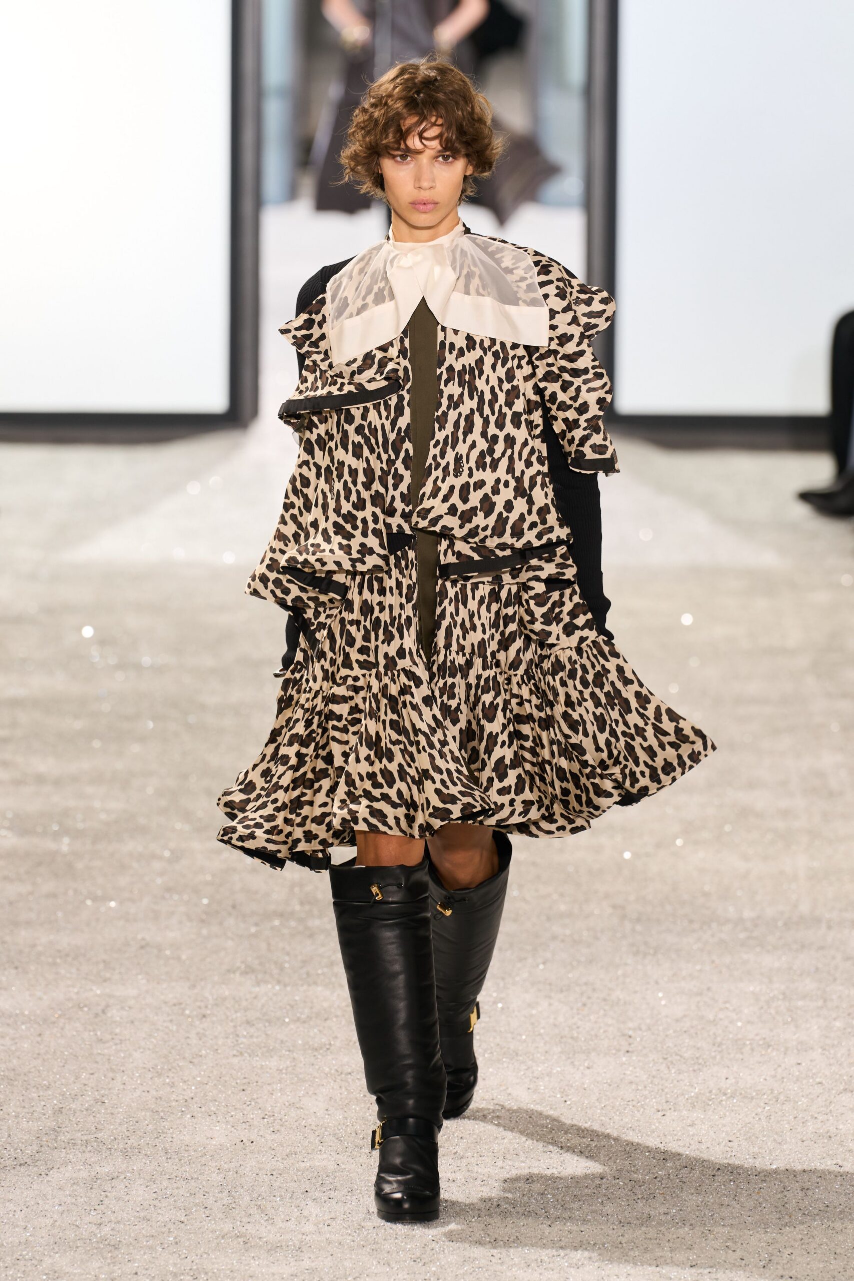 beige and black ruffled midi dress with boots