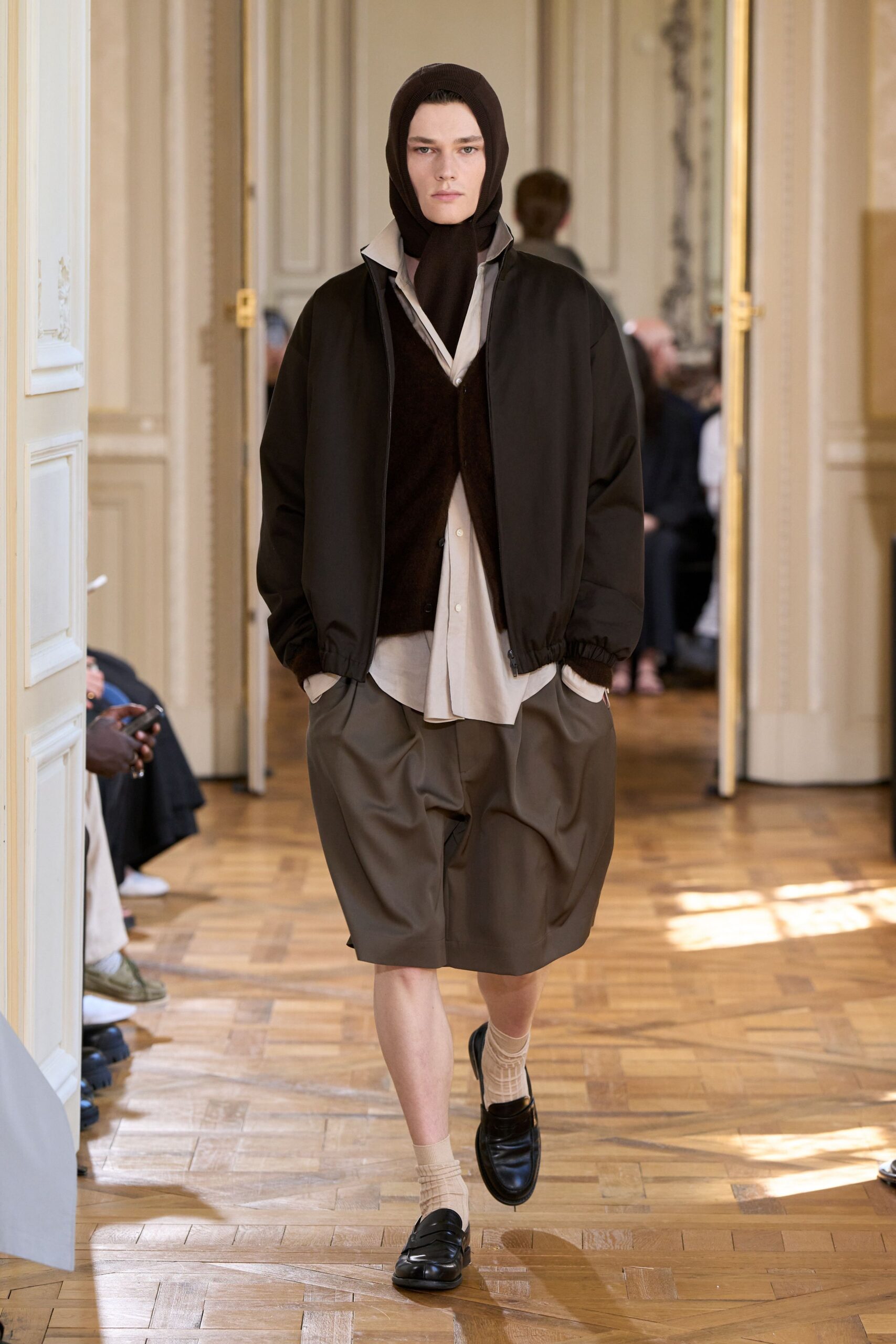 black jacket white shirt brown sweater
