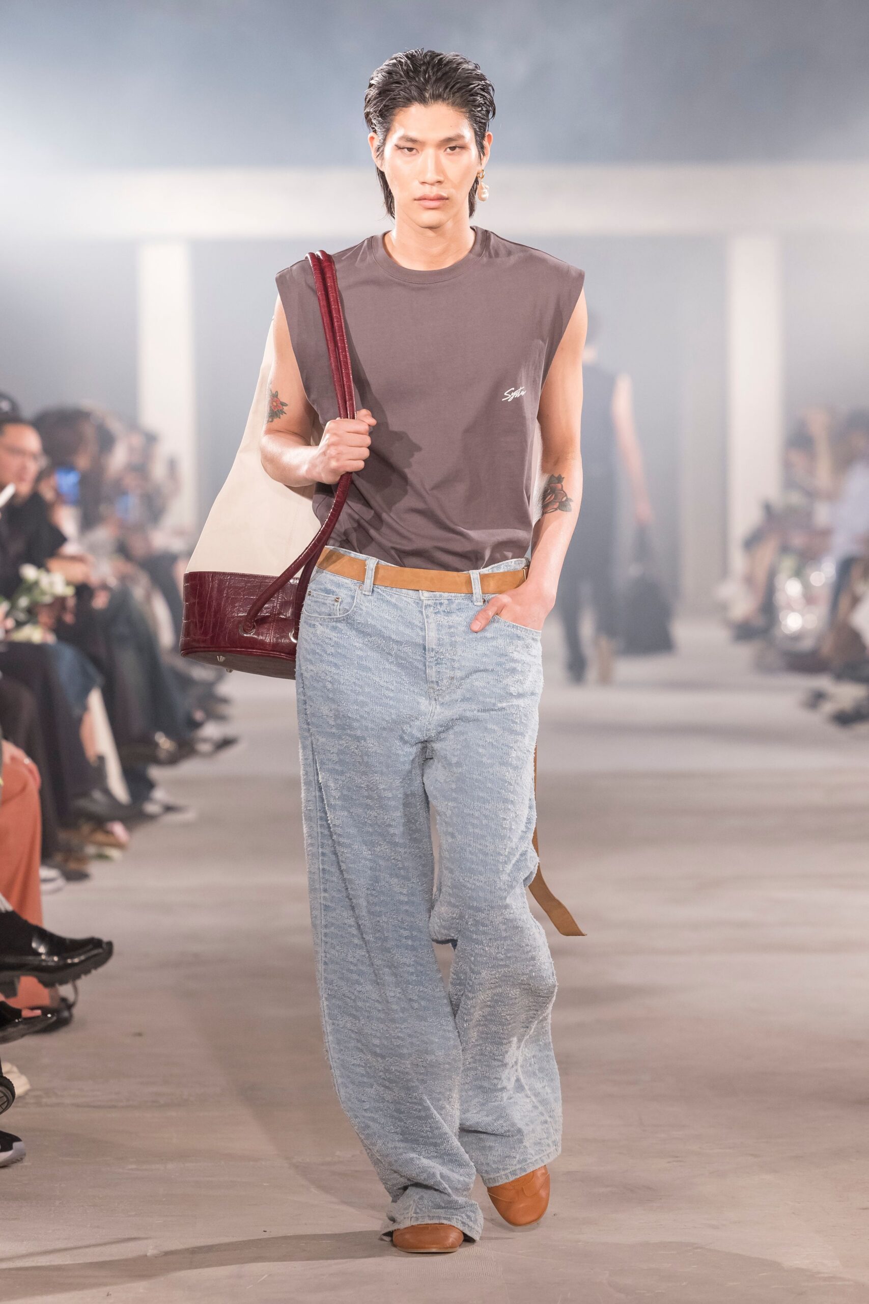 gray sleeveless t-shirt with blue pants