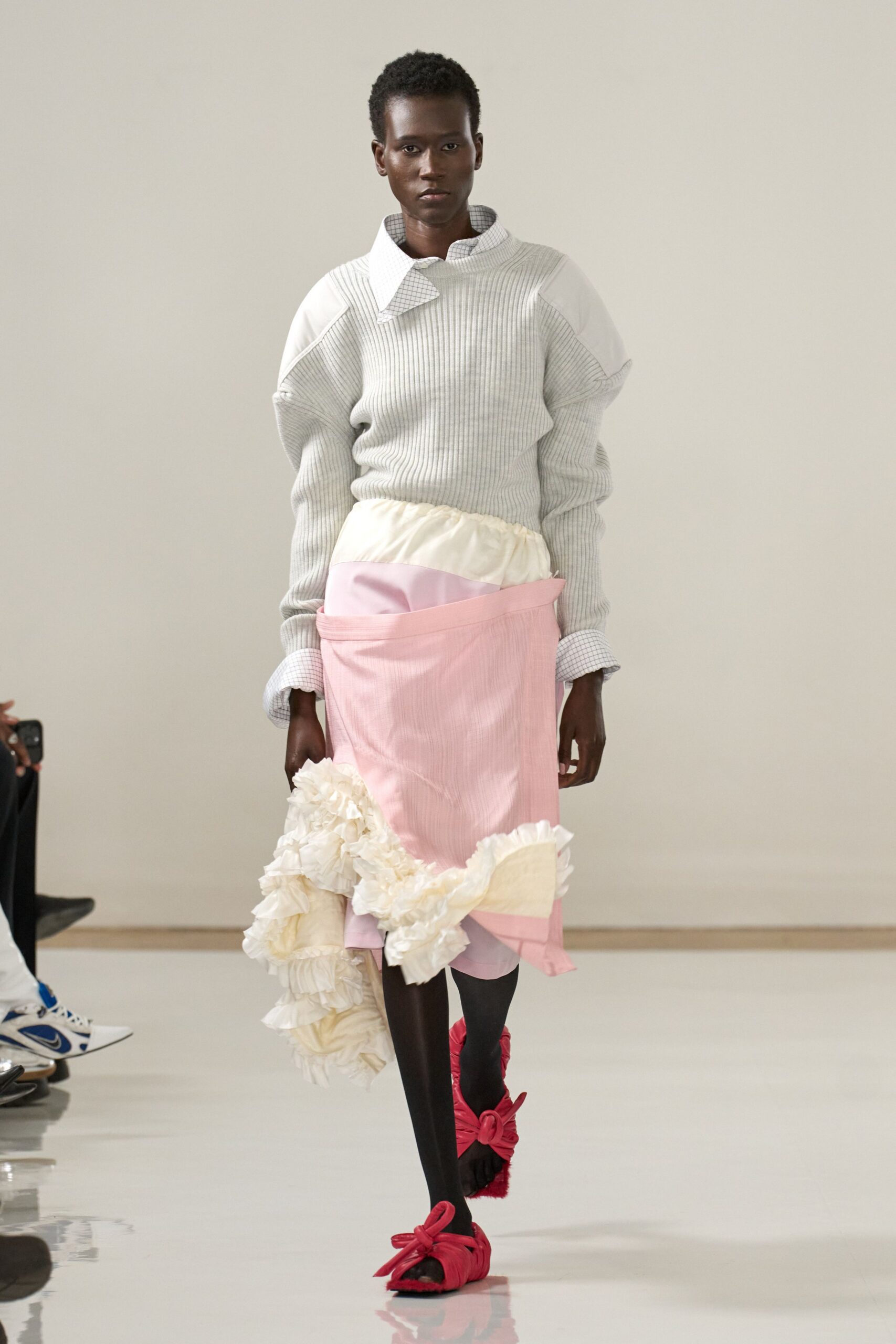 gray relaxed sweater with pink ruffled skirt