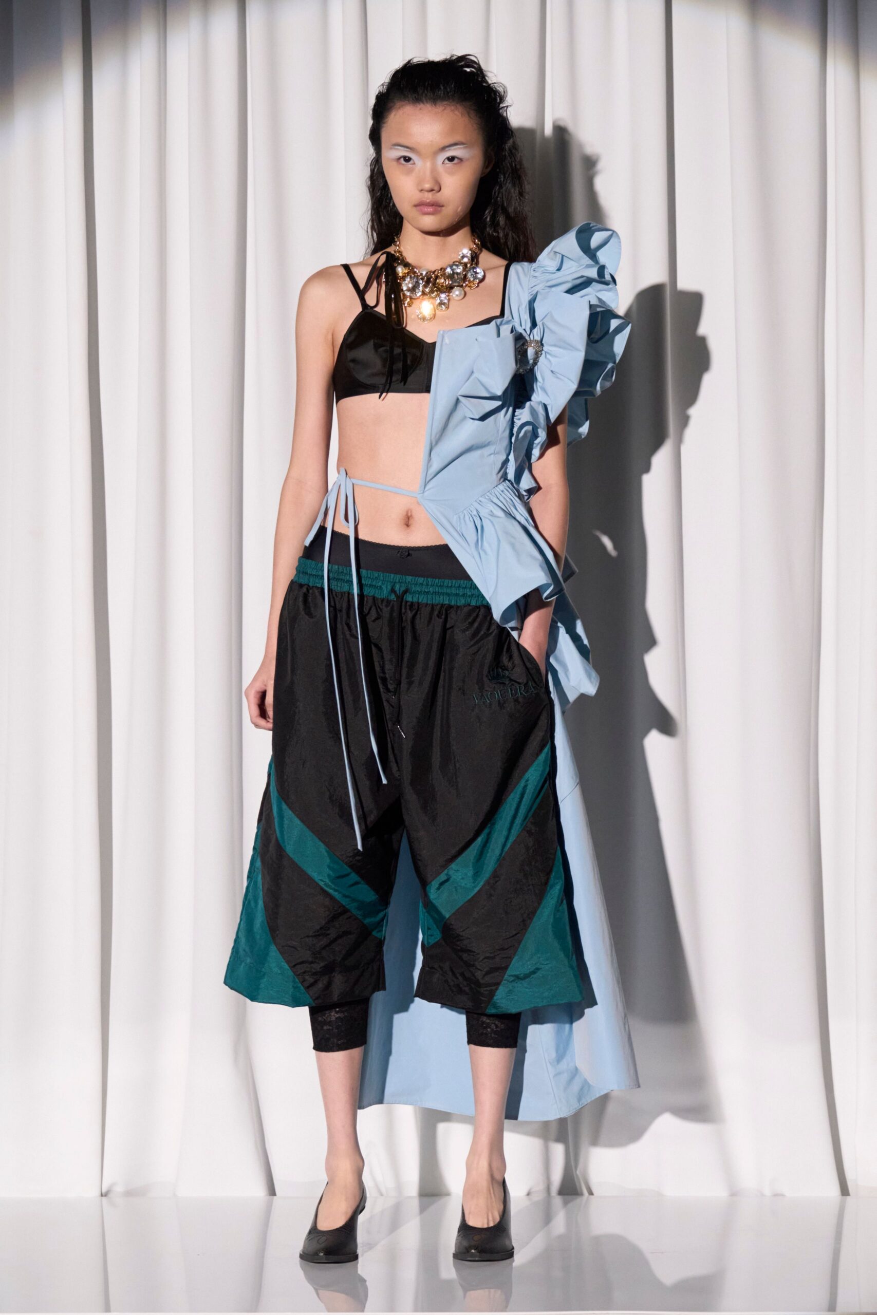 black top teal pants blue coat