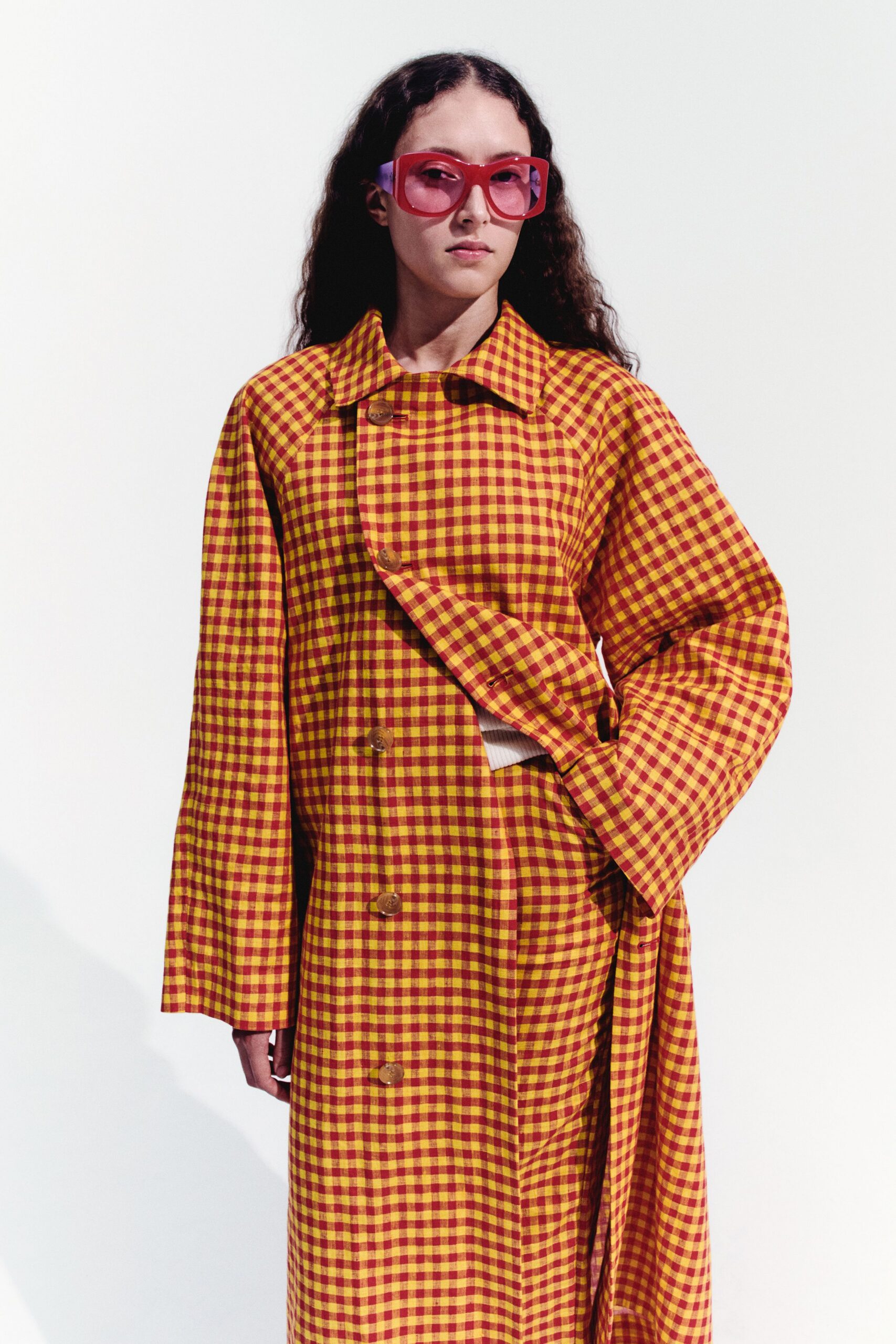 checked yellow and red coat with sunglasses