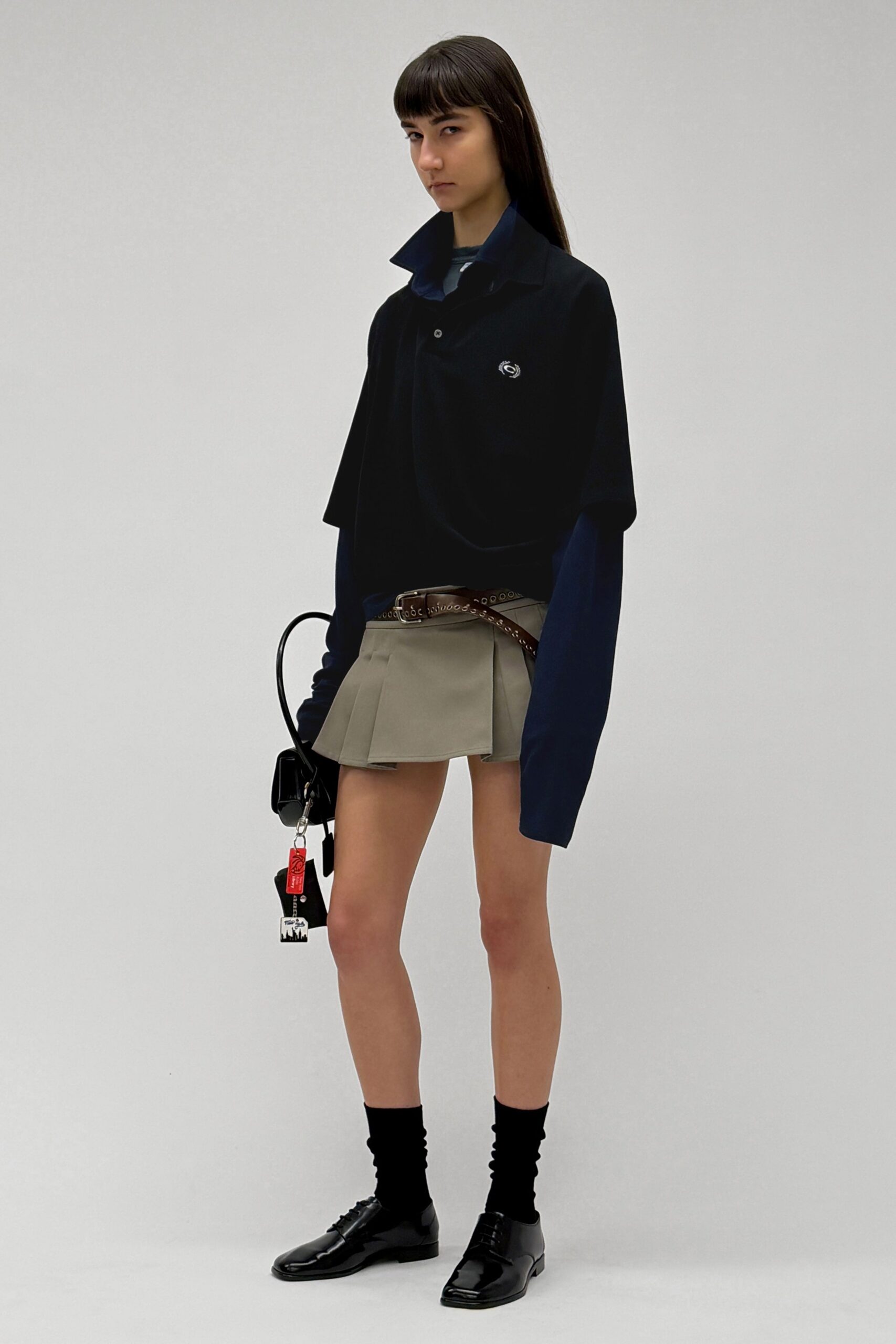 oversized black shirt with pleated skirt