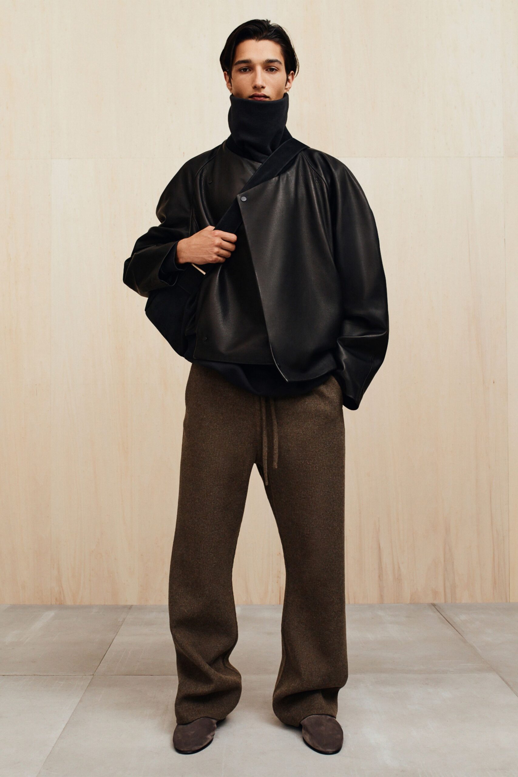black leather relaxed jacket with brown wool pants