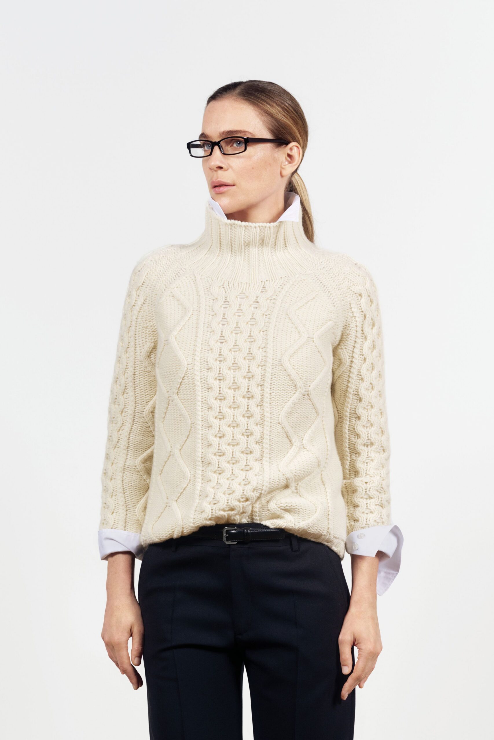 white wool turtleneck sweater with black tailored pants