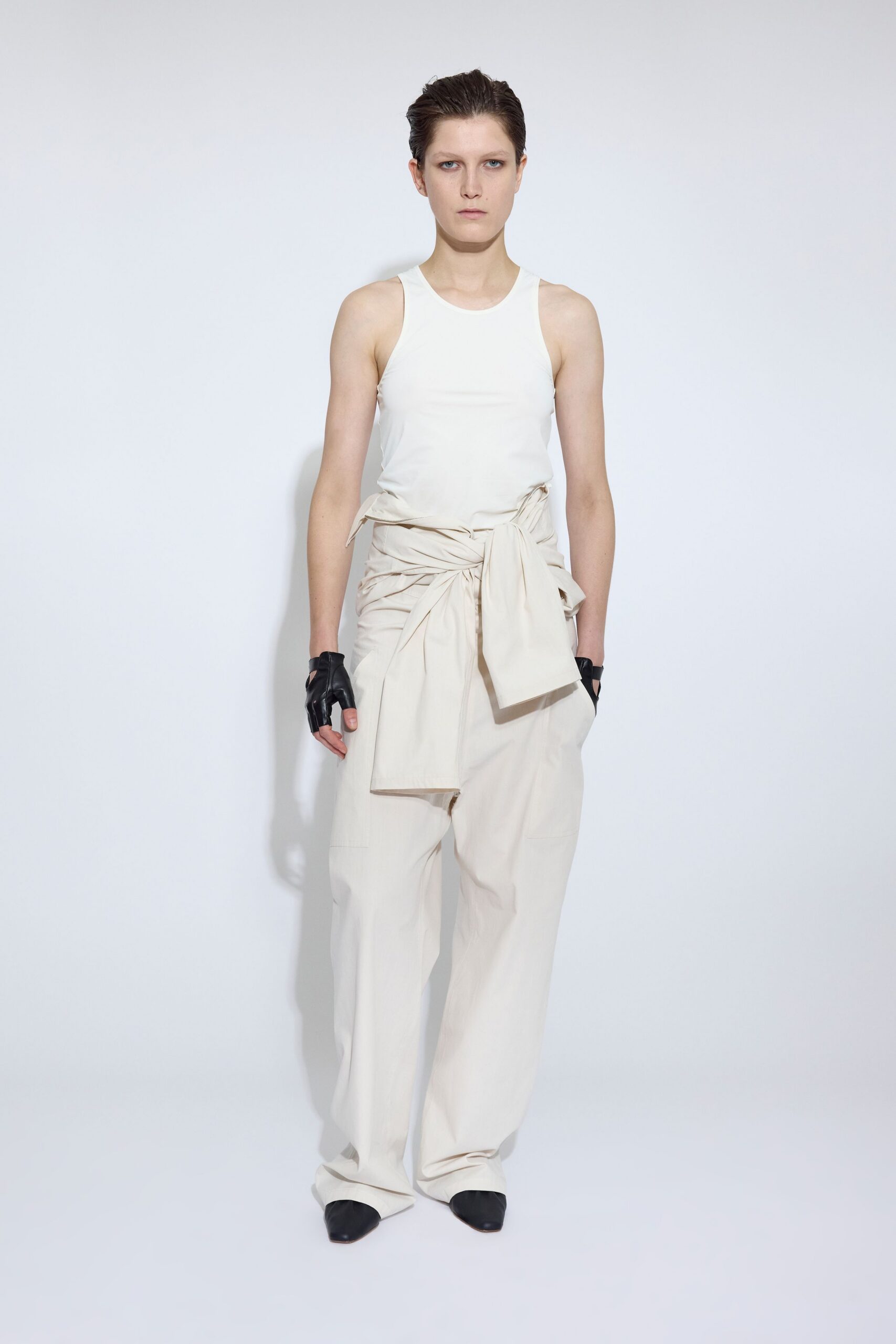 white tank-top beige pants