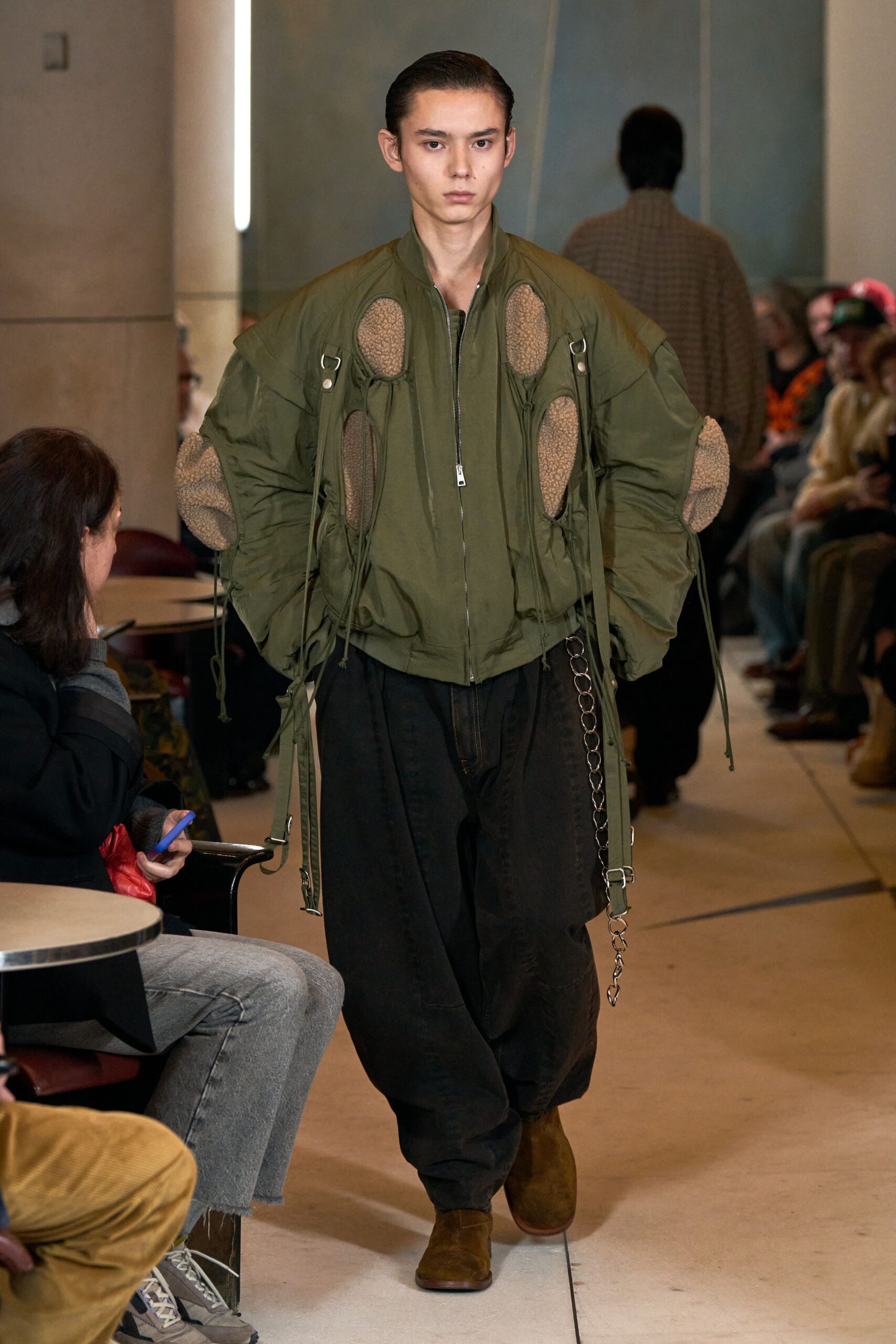 green oversized jacket with black pants
