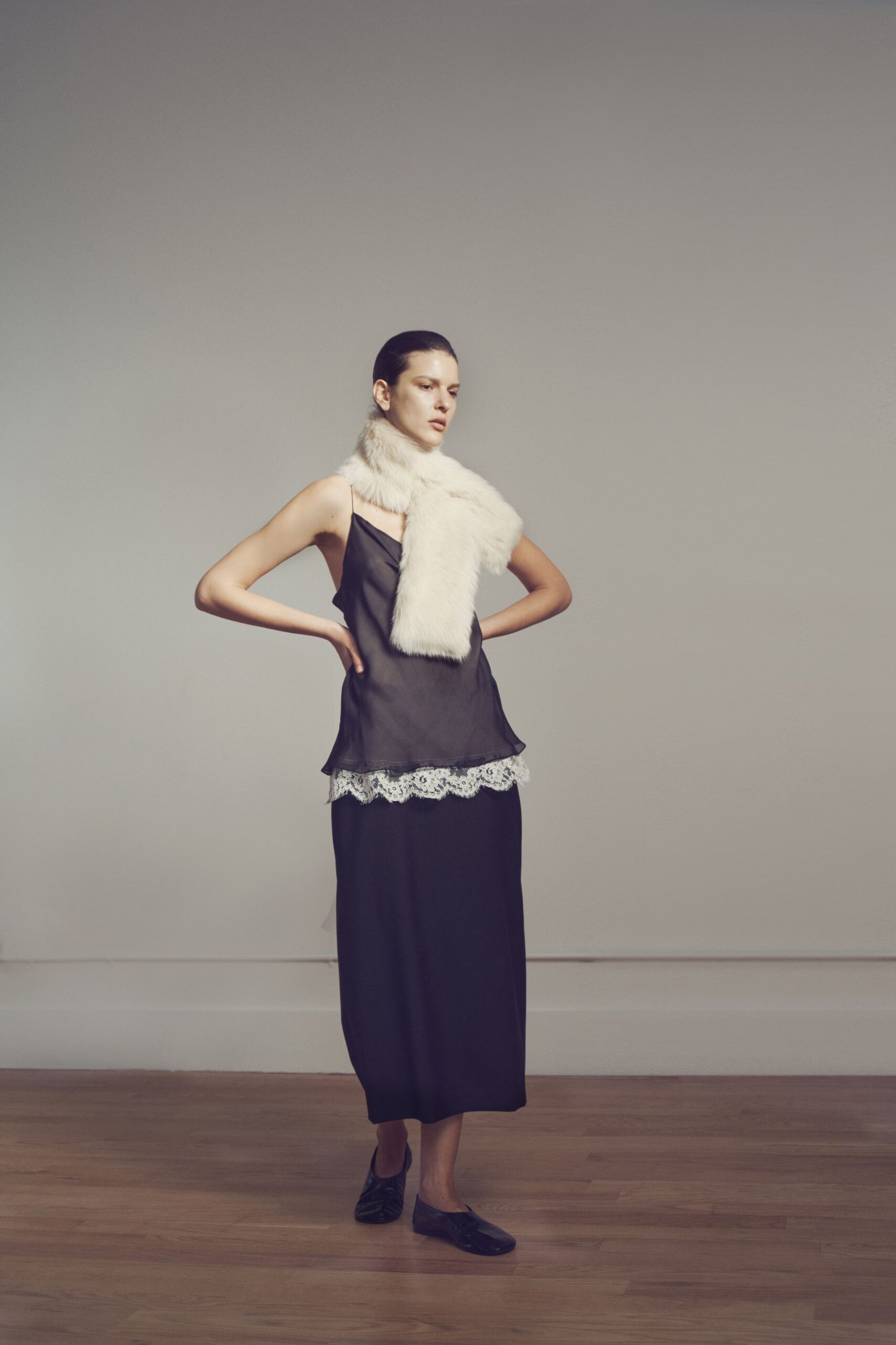 black silk top and skirt with white fur scarf
