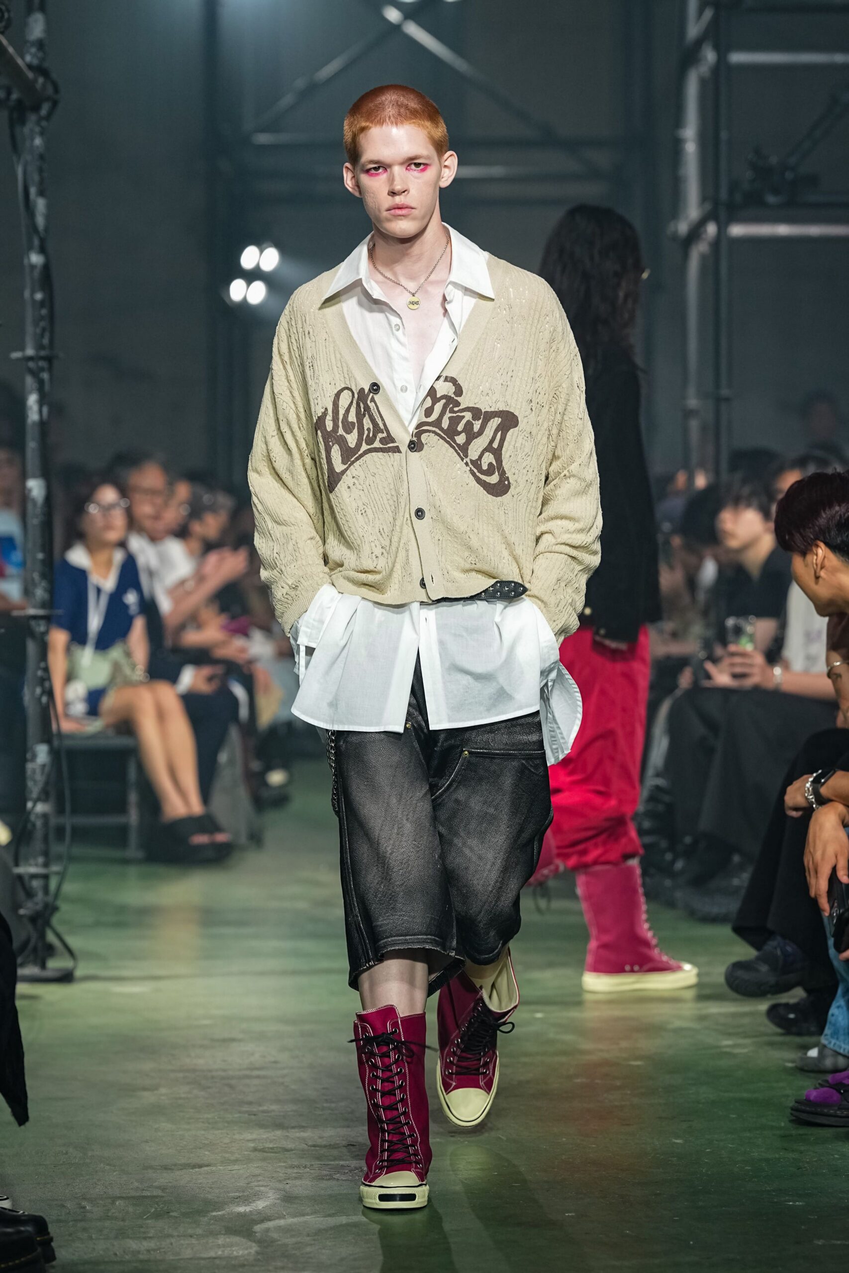beige cardigan white shirt black pants red boots