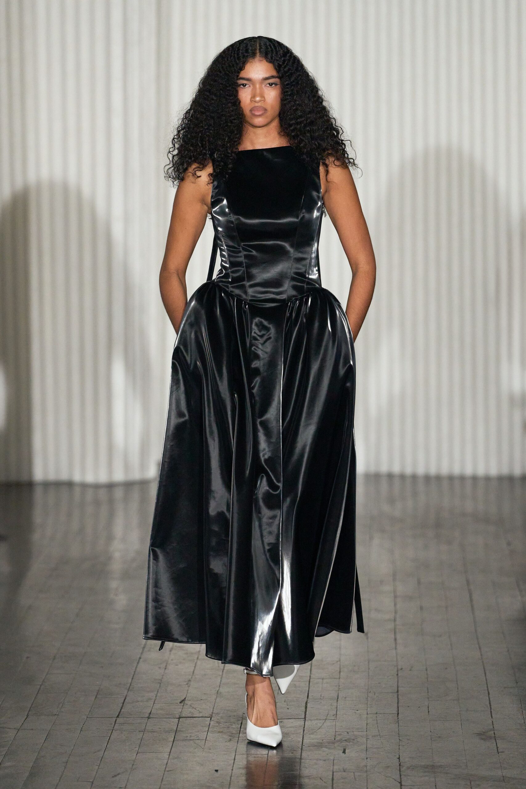 black silk sleeveless gown with white shoes
