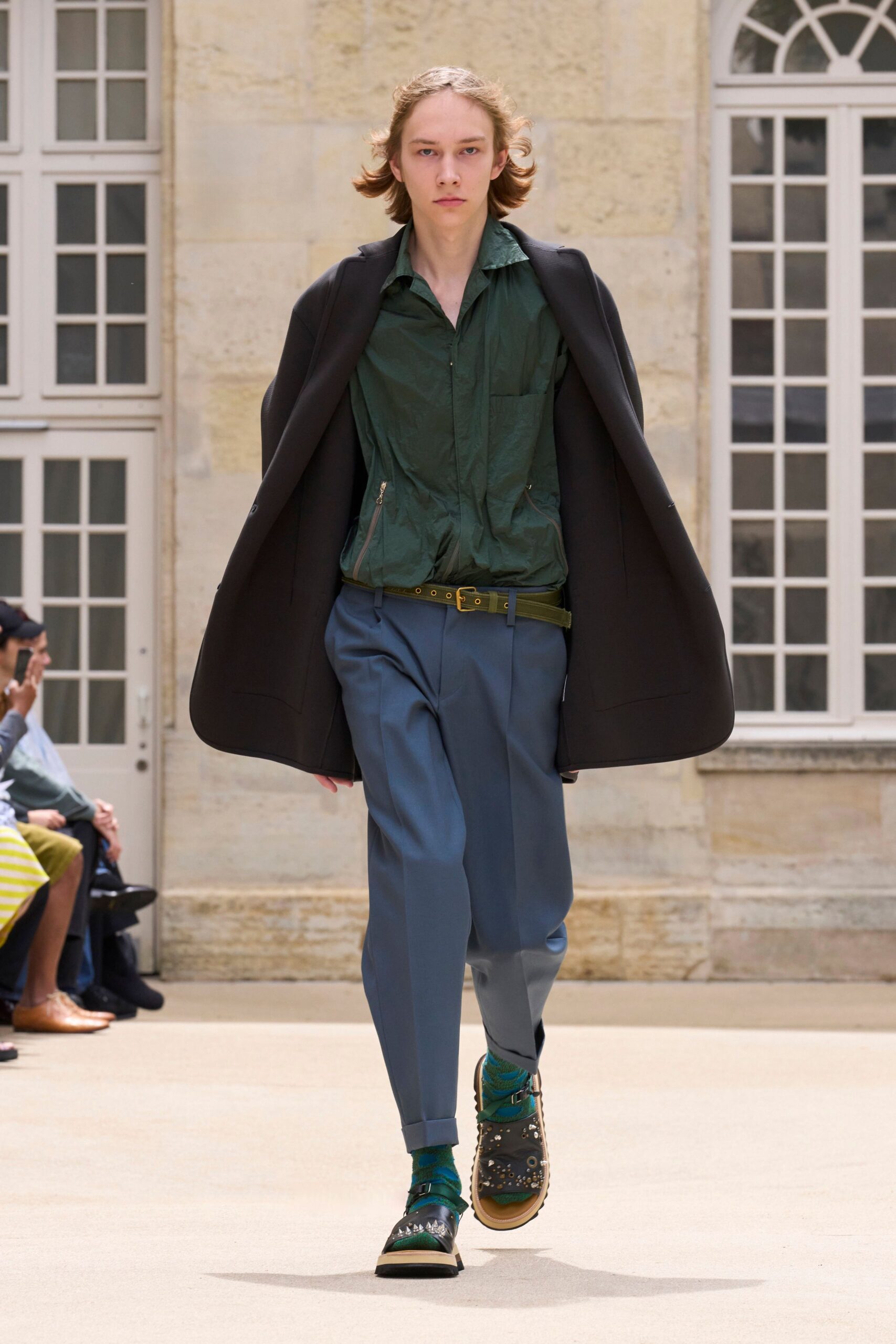 green shirt black coat blue pants