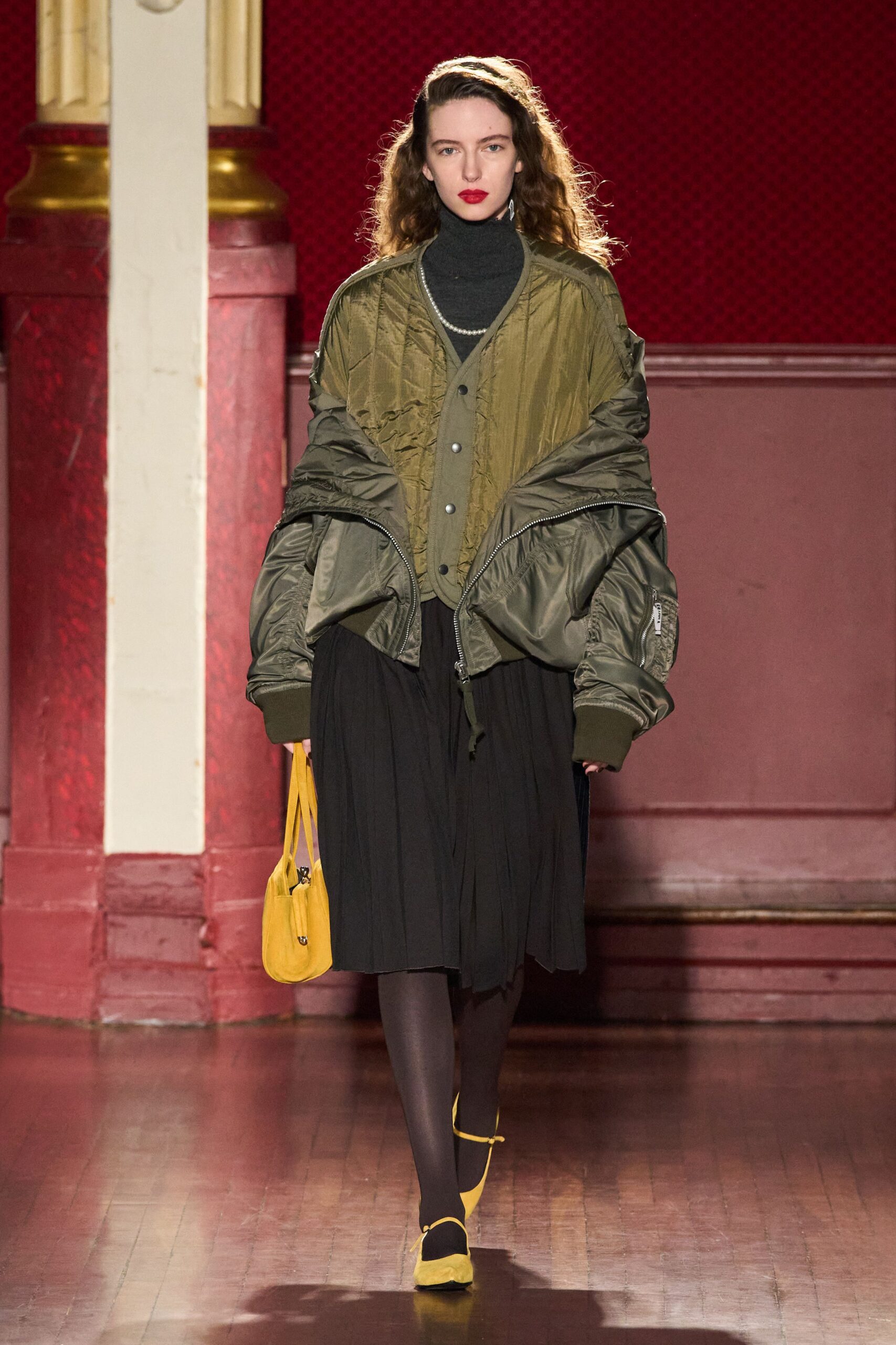oversized green jacket with pleated black skirt