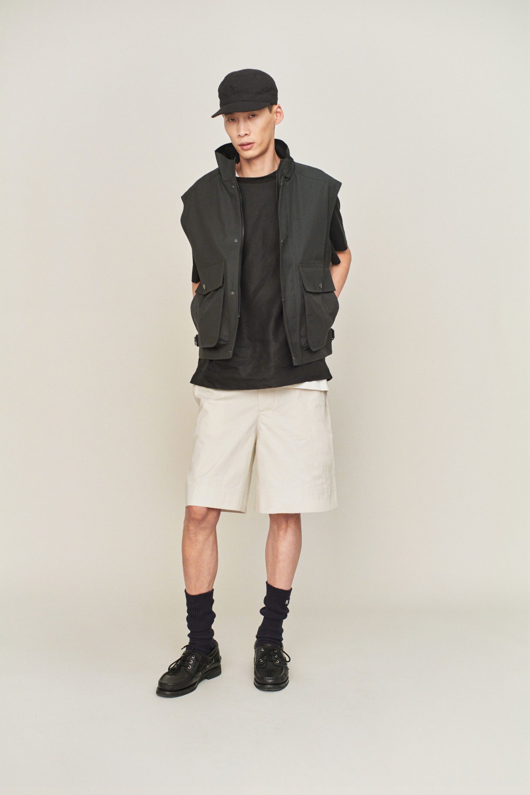black vest with beige shorts