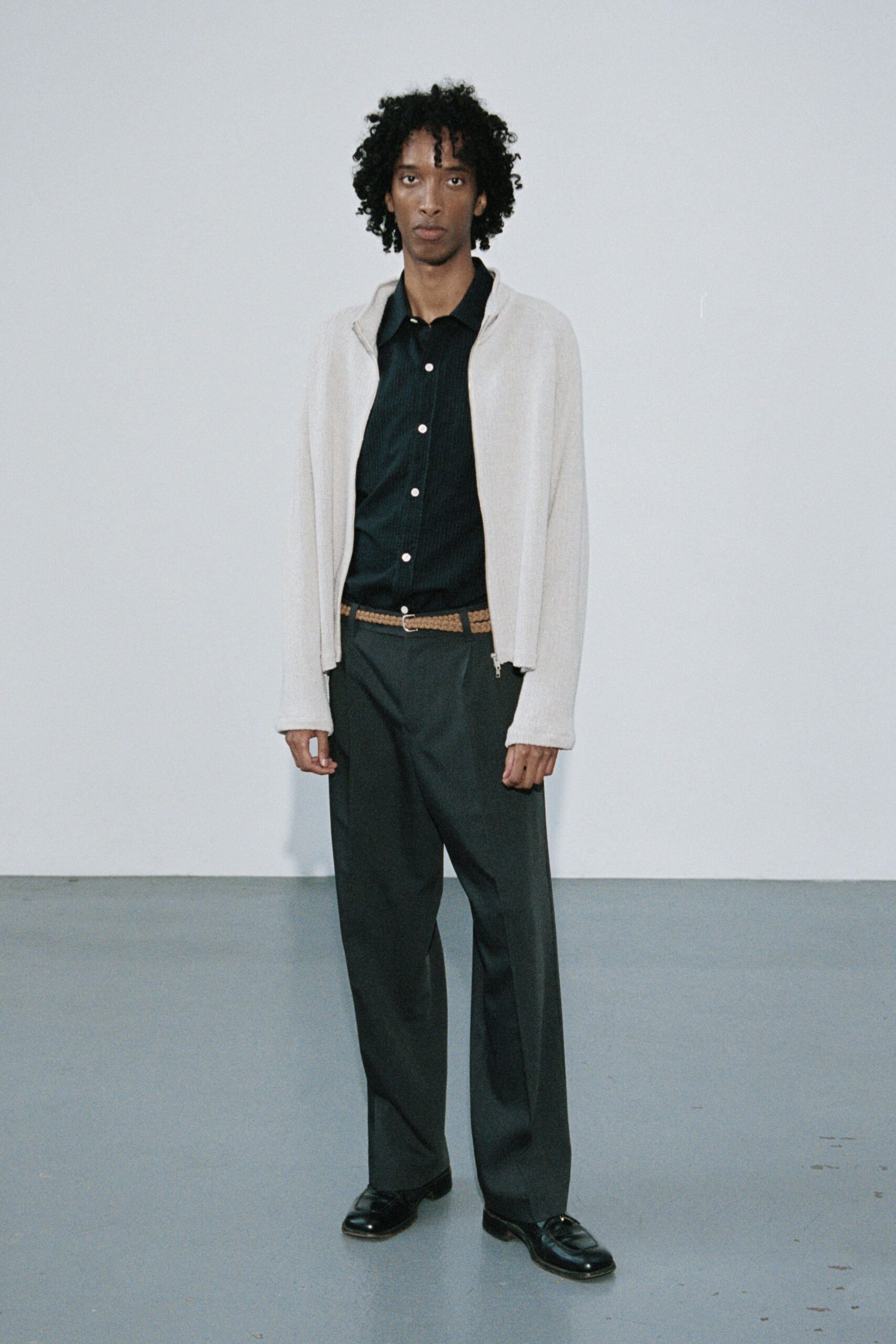 beige cardigan black shirt gray pants