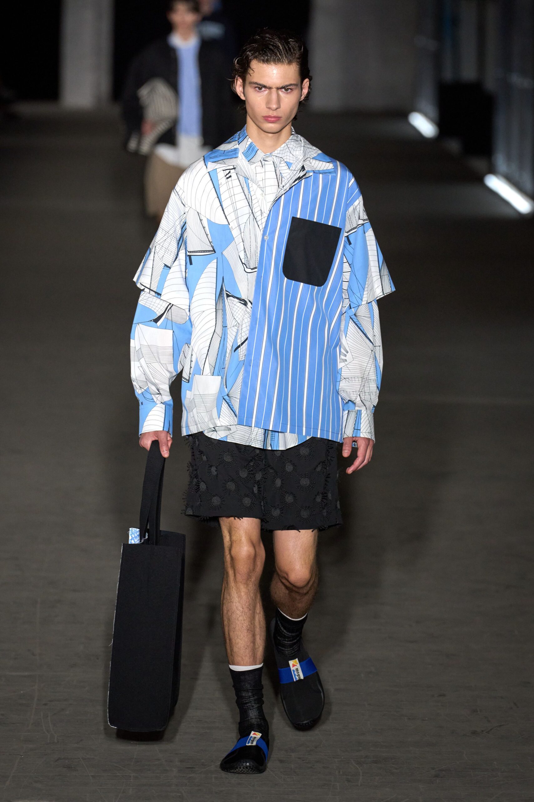blue and white printed shirt with black shorts