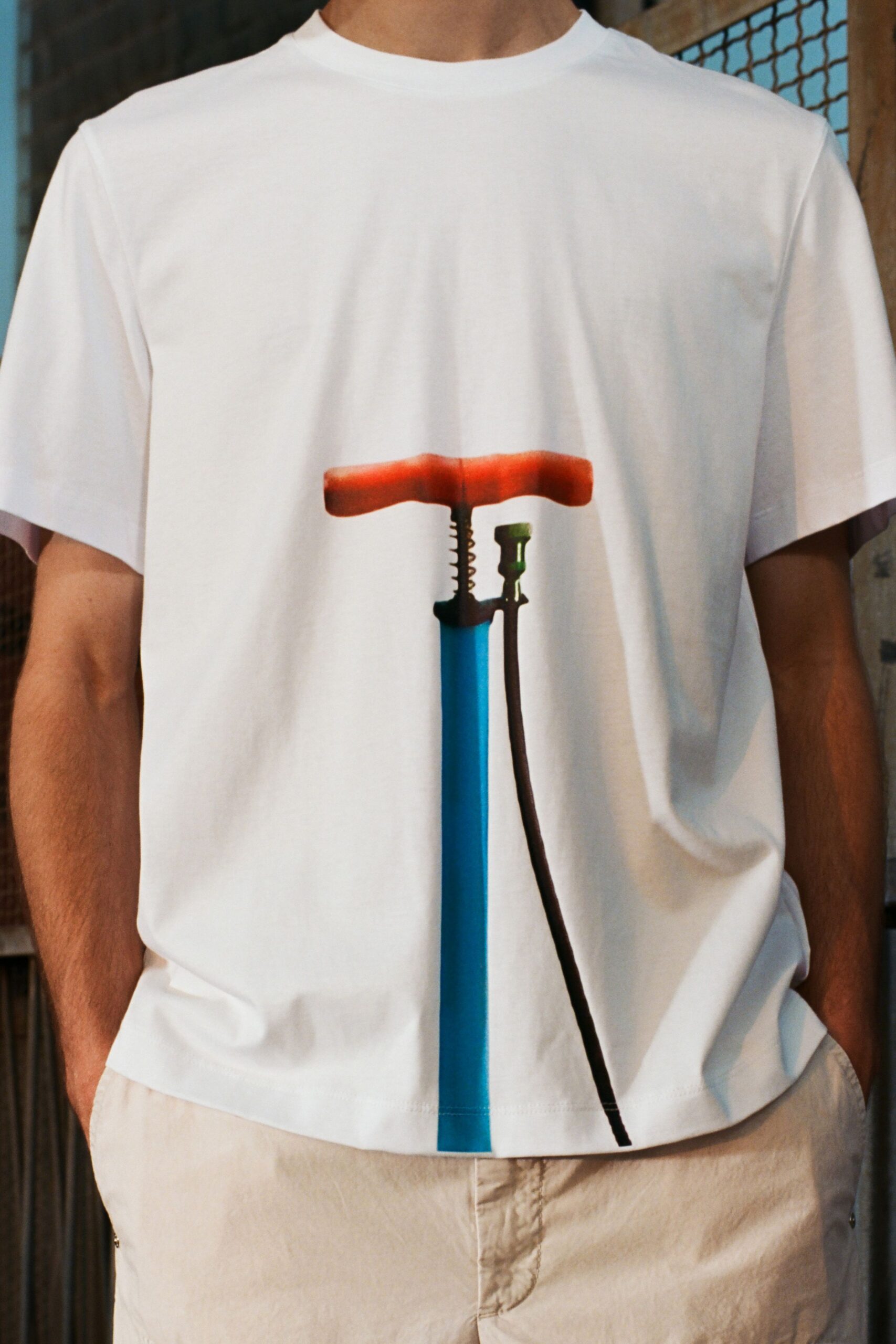 white printed t-shirt and beige shorts