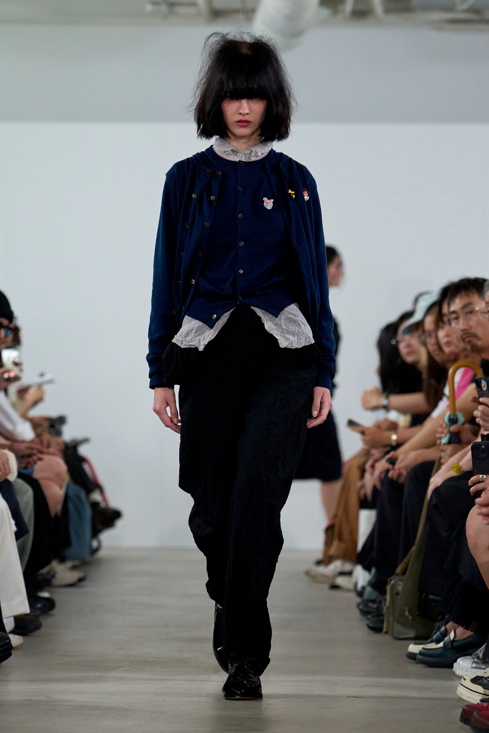 blue cardigan white shirt black pants