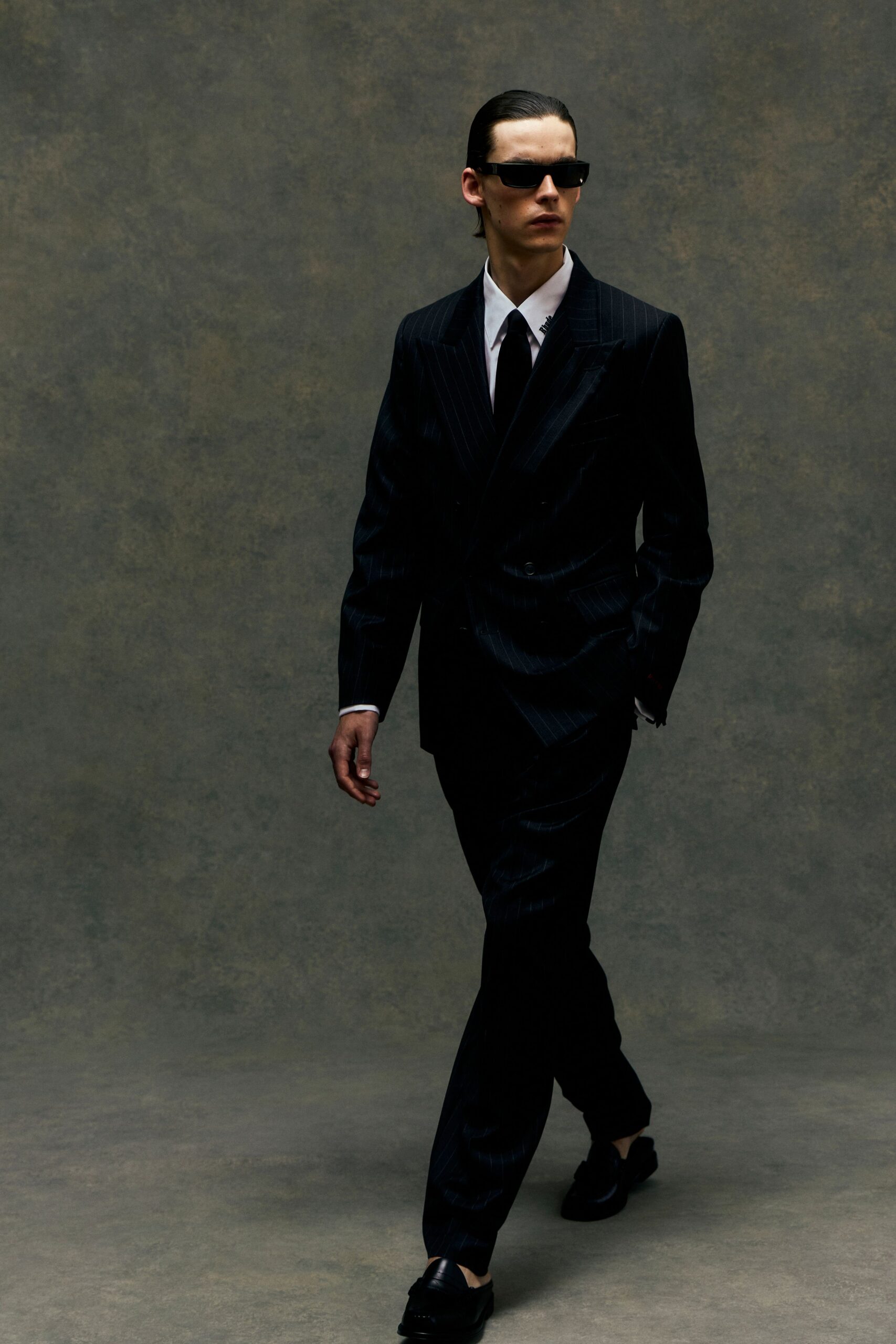 black tailored suit with sunglasses