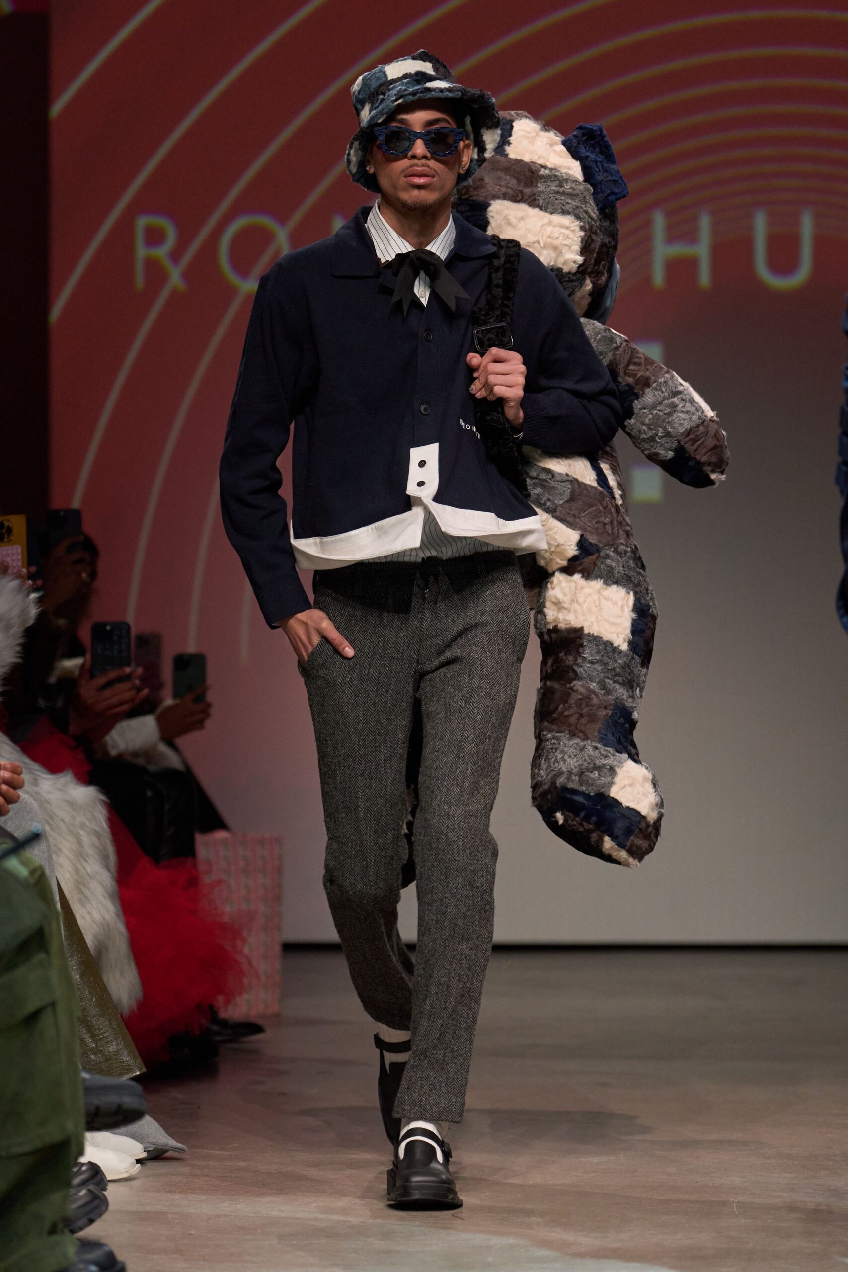fitted navy jacket with gray pants