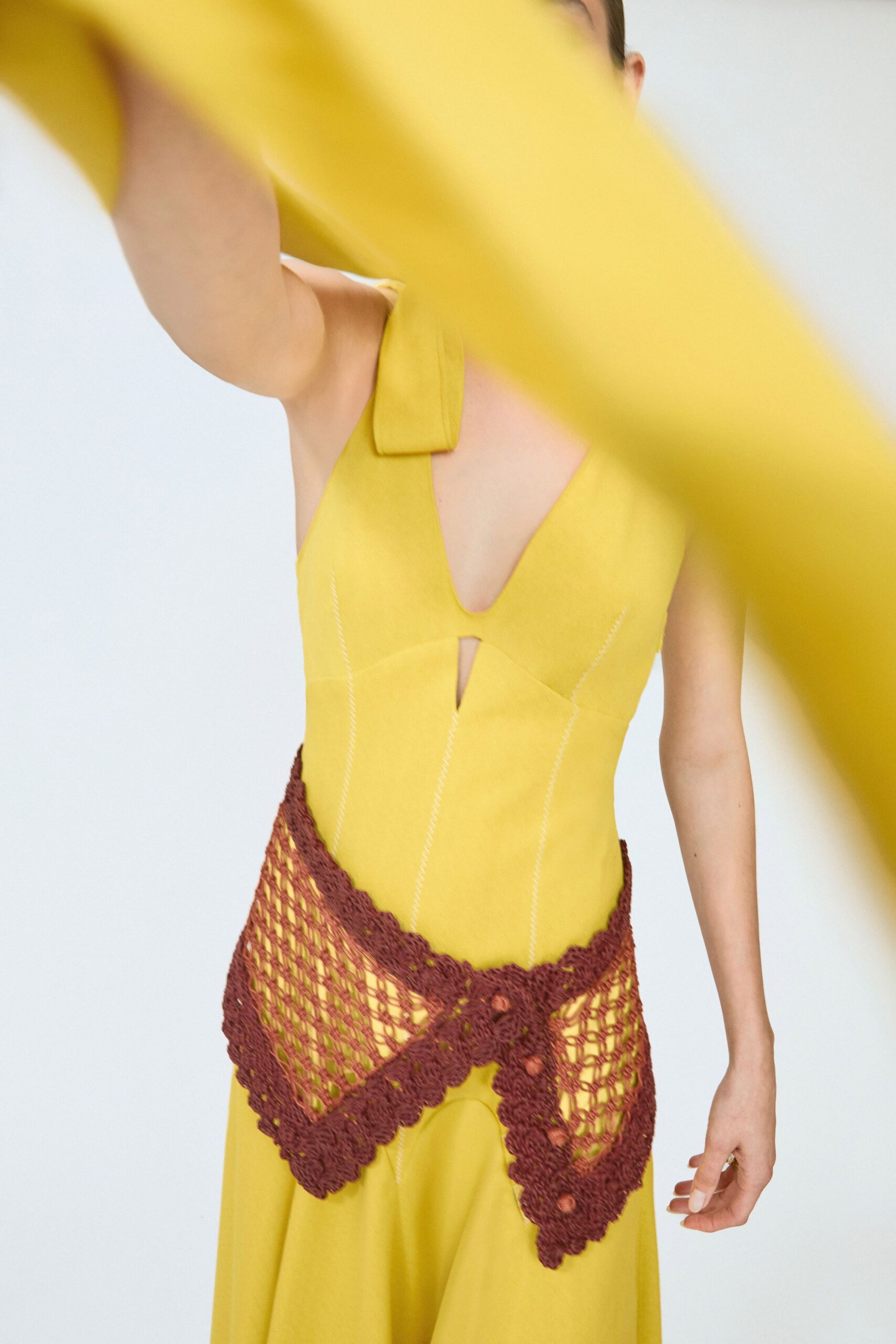 yellow fitted dress with brown belt