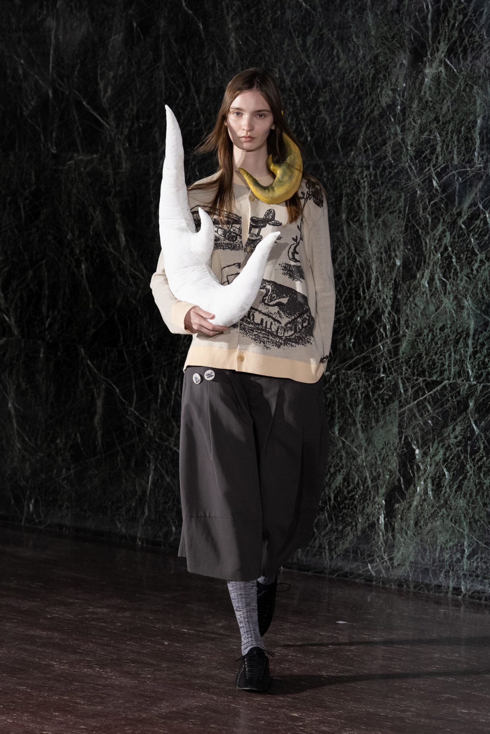beige printed top with black pants