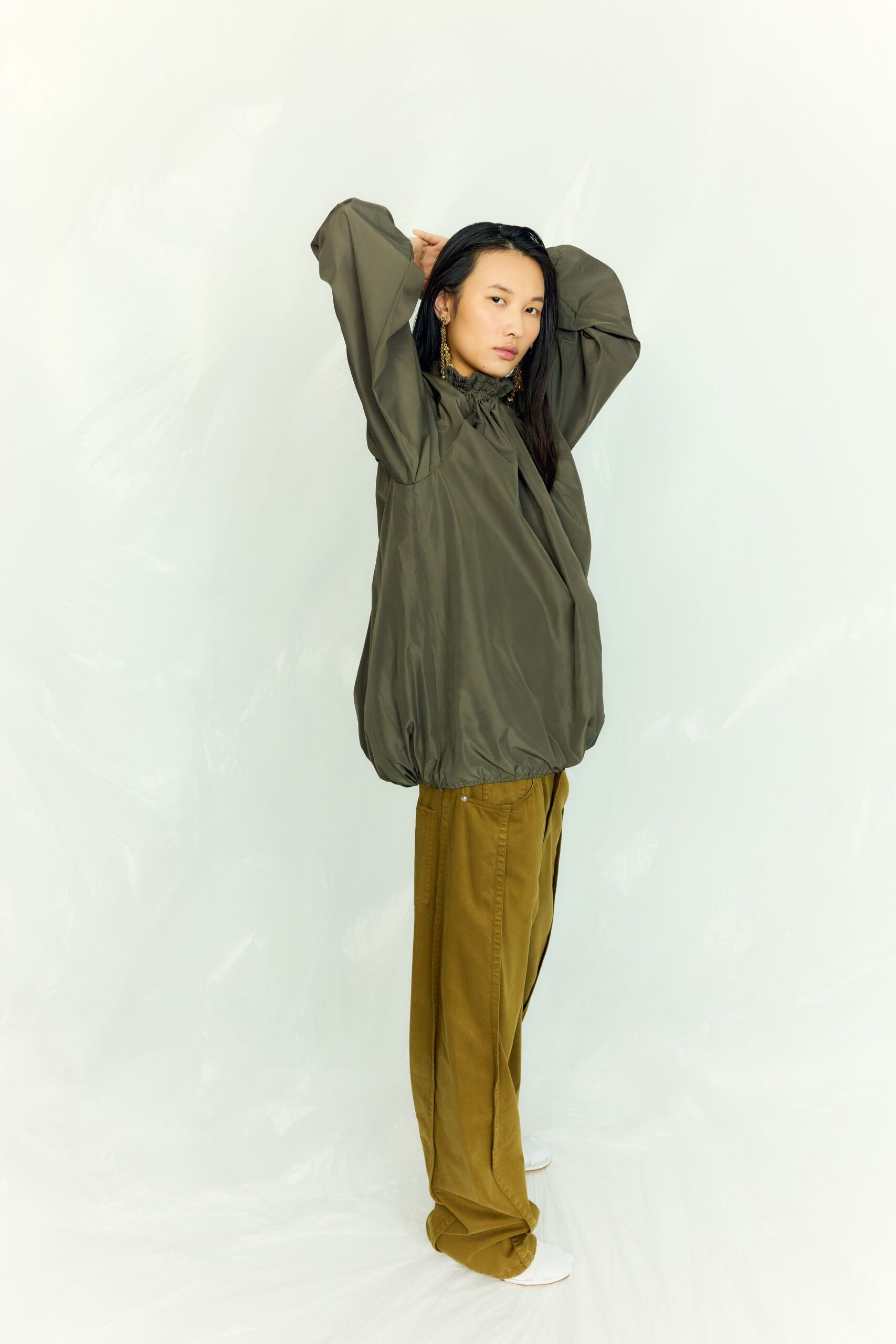 green relaxed jacket and brown pants