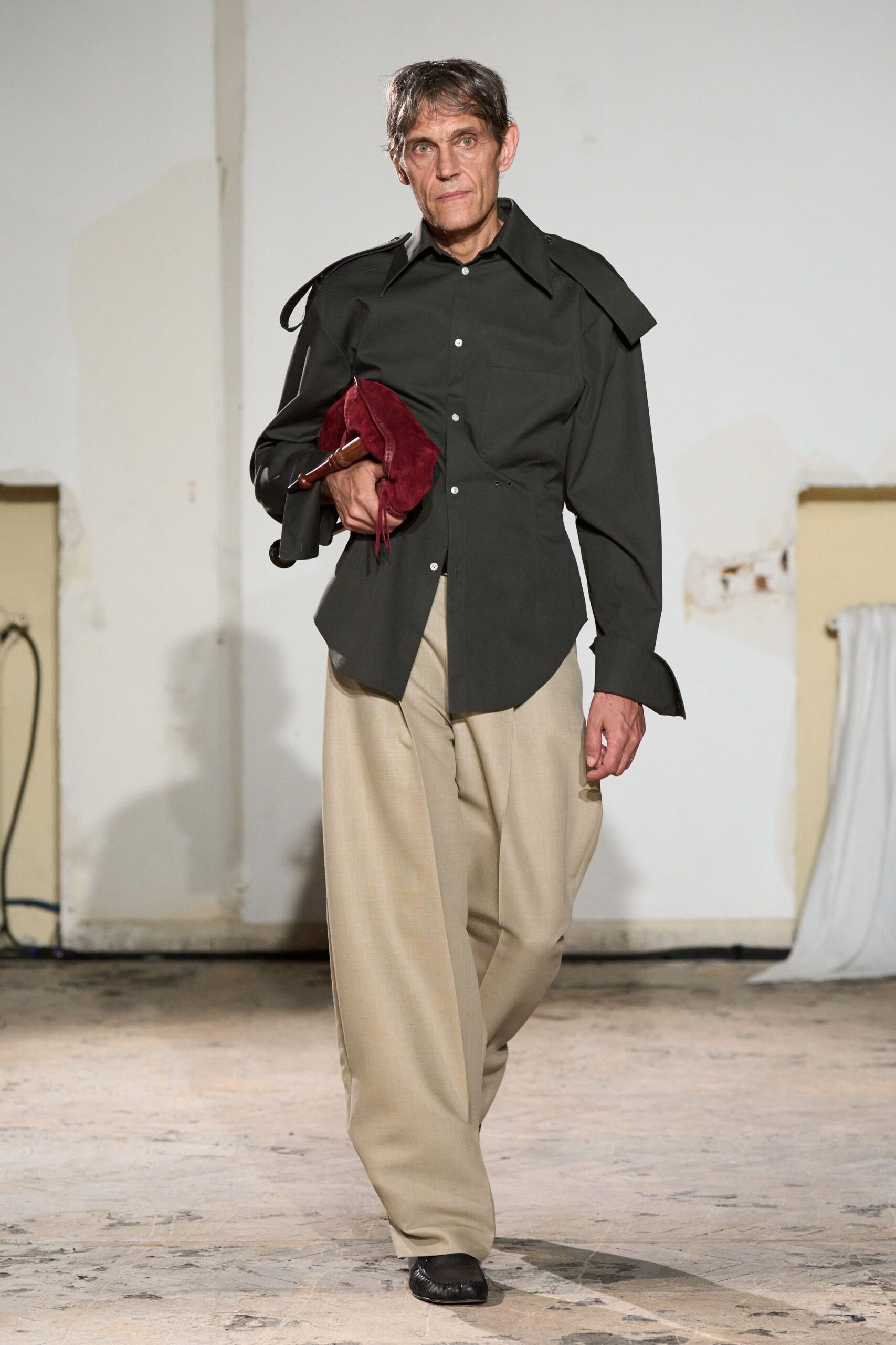 black shirt beige pants red bag