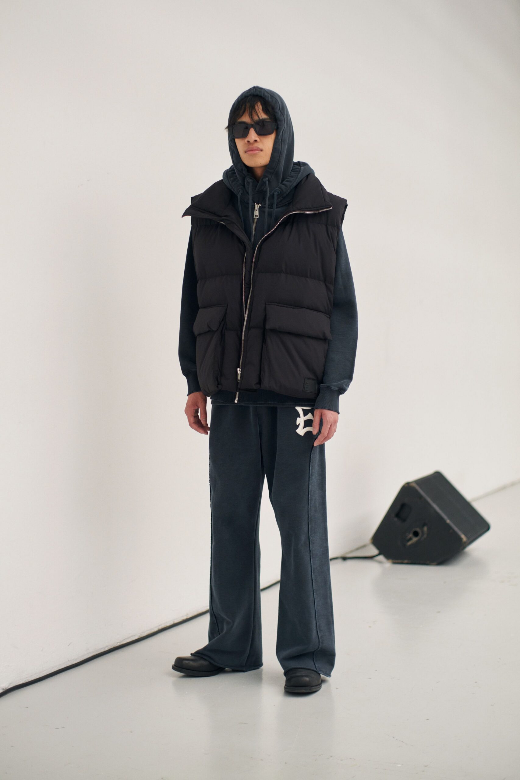 black vest gray hoodie blue pants