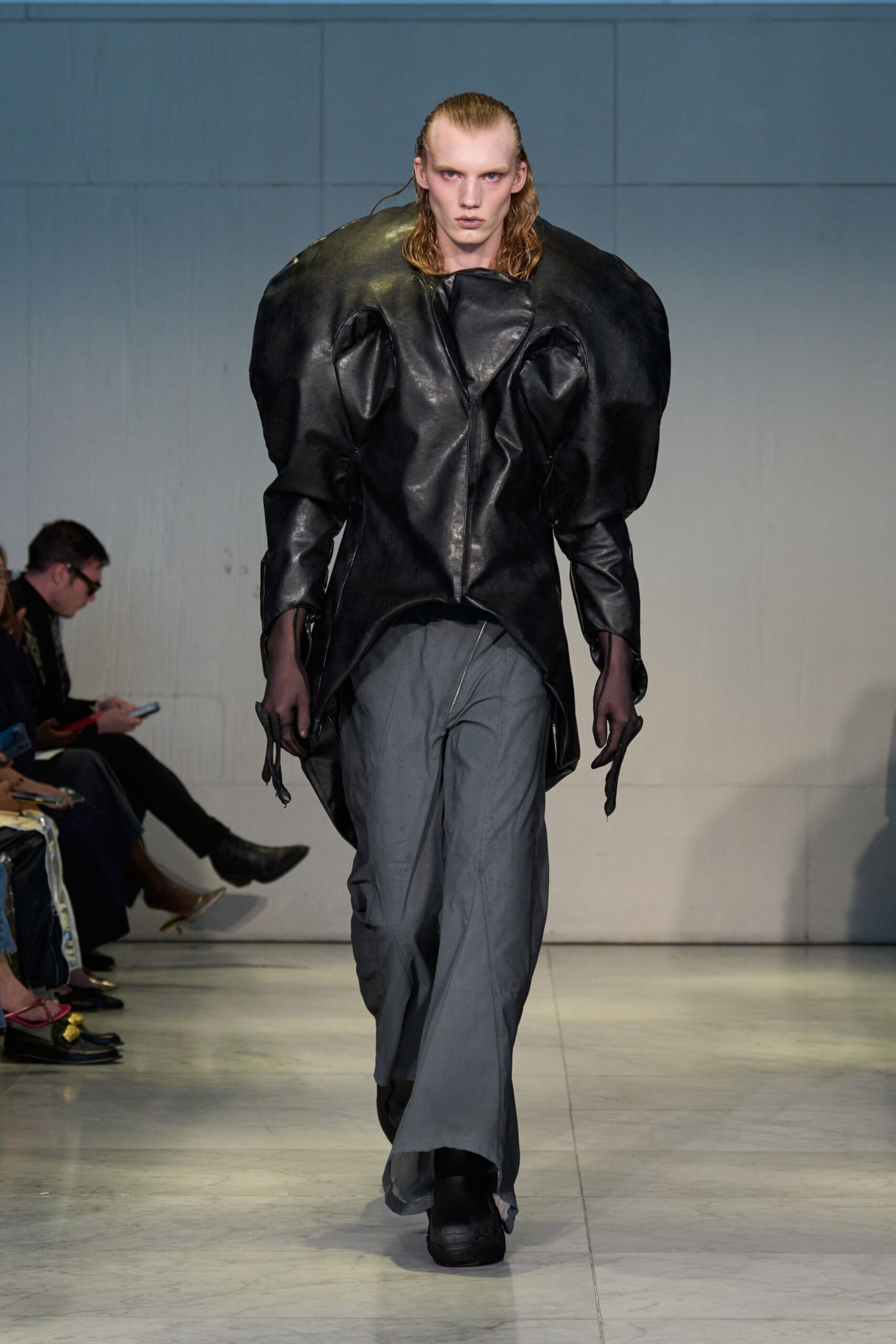 black leather structured jacket with gray pants